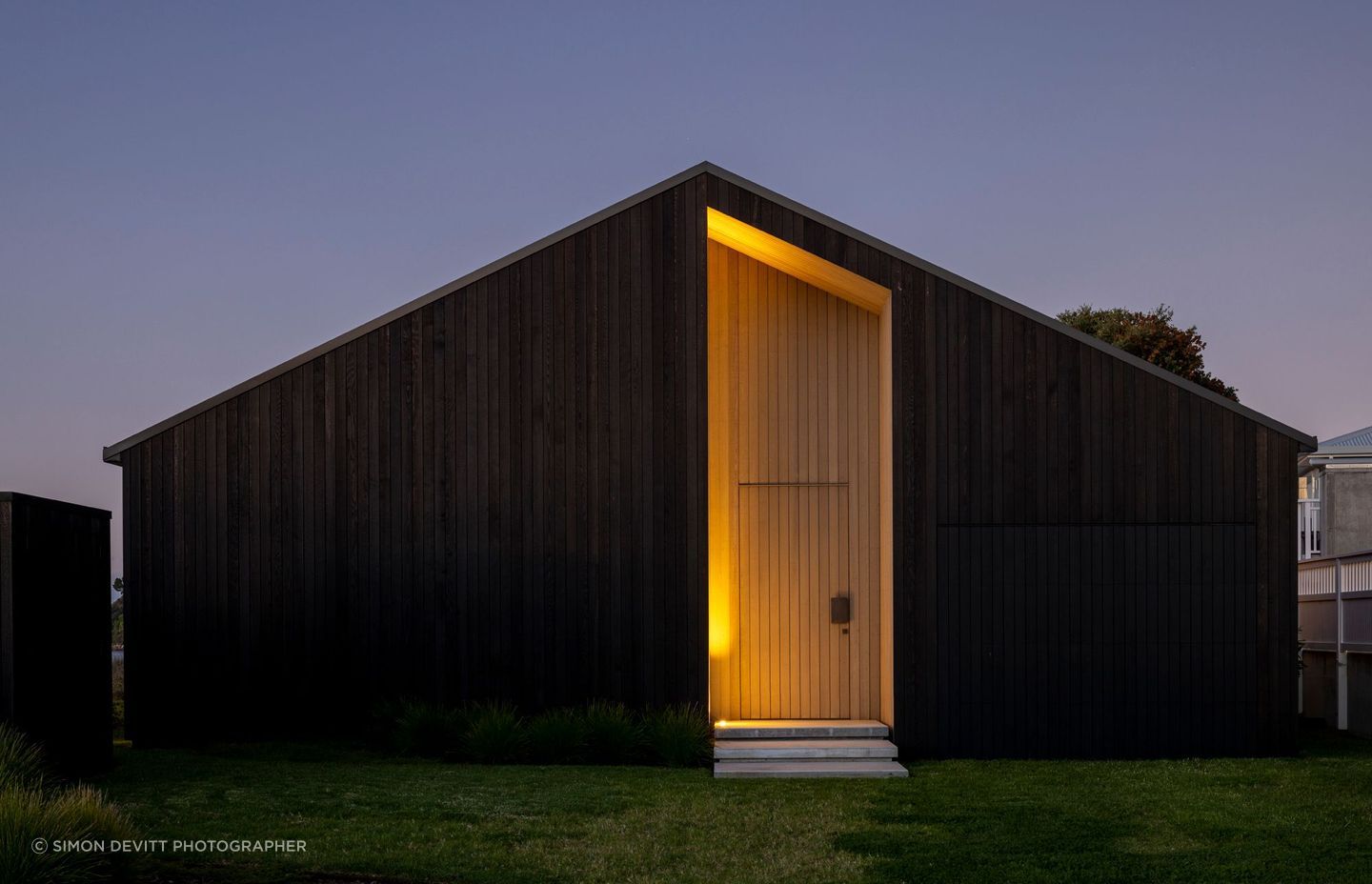 The darkly clad street elevation has no windows.