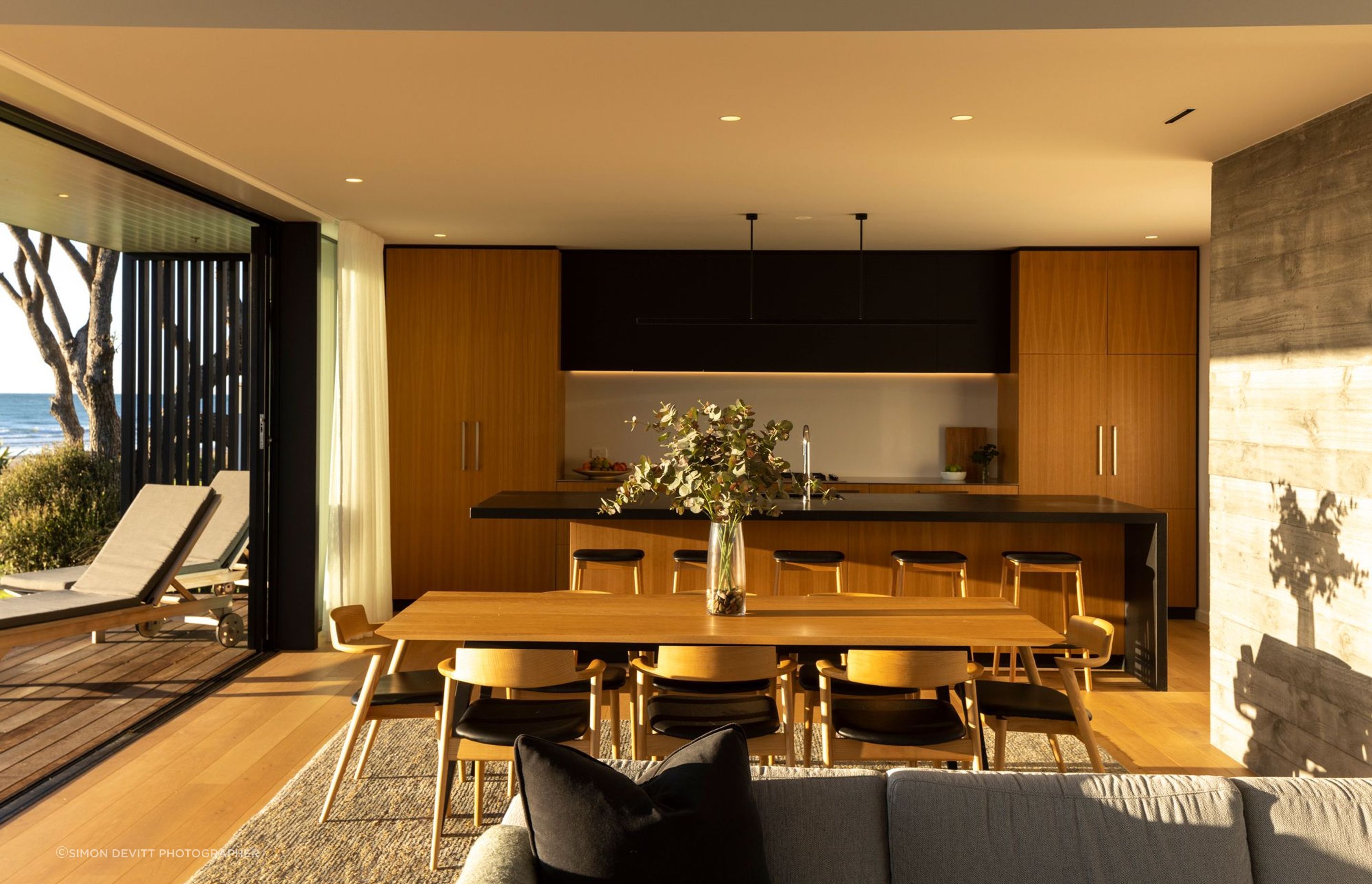 The morning light illuminates the kitchen, dining and living space.