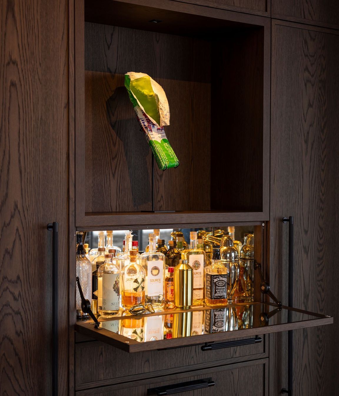 A mini-bar concealed in the kitchen cabinetry. The homeowners are art collectors - the K Bar sculpture is by Simon Lewis Wards.