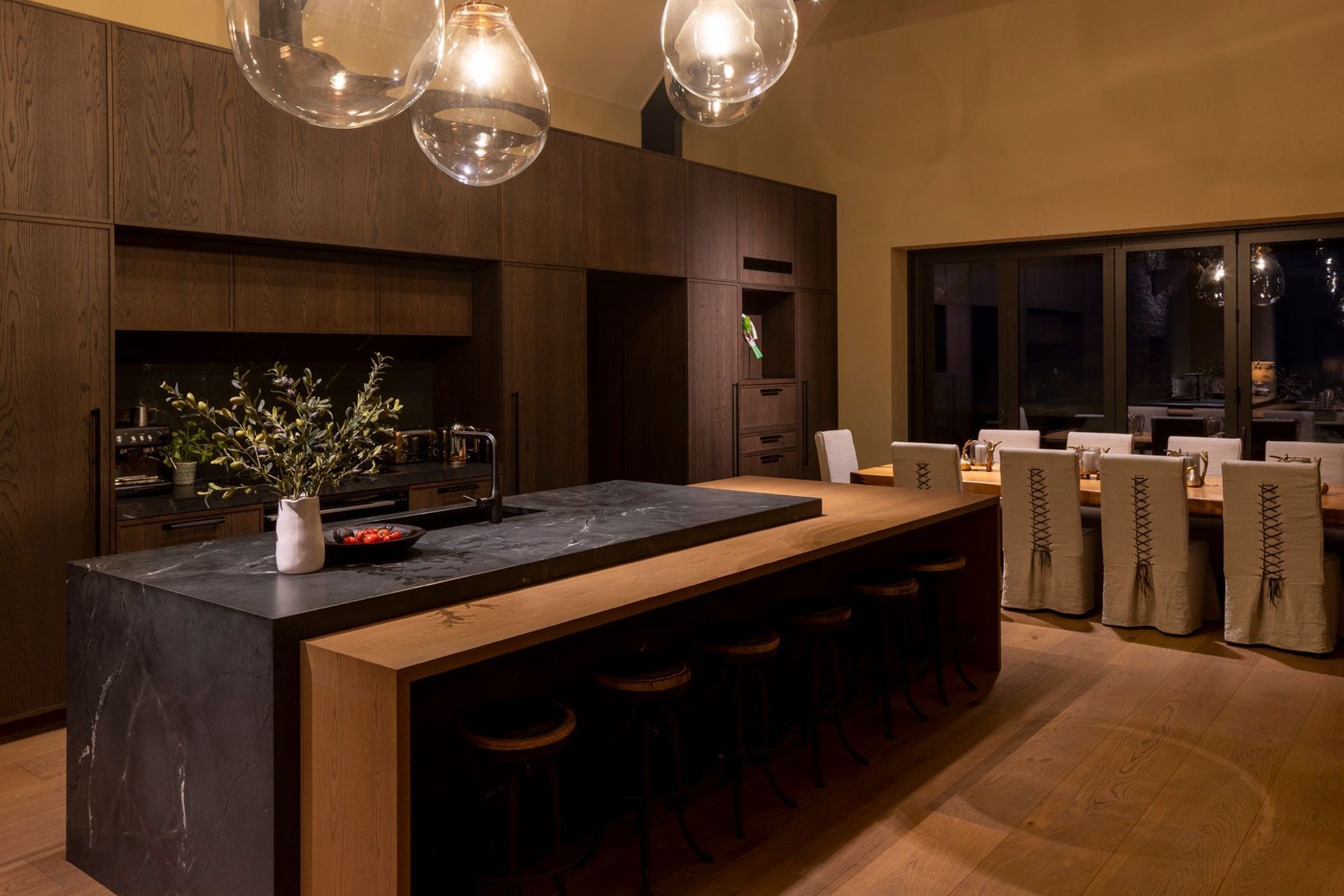 “The dining table is a swamp kauri slab from Dargaville, which was found early on and then a base was constructed for it. The dining chairs were custom made with leather detailing on the back,” says Vee.