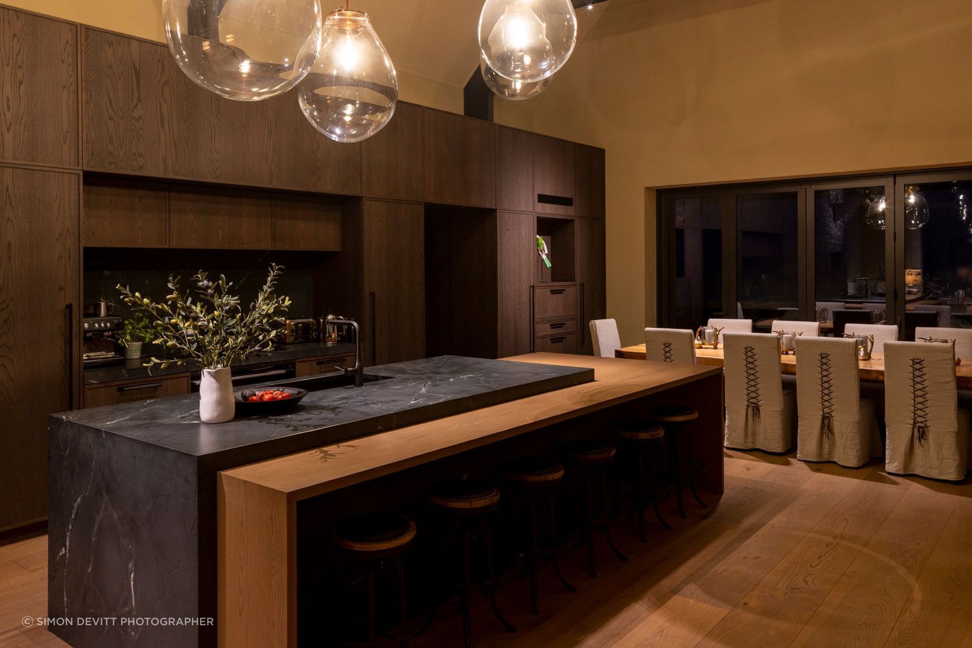 “The dining table is a swamp kauri slab from Dargaville, which was found early on and then a base was constructed for it. The dining chairs were custom made with leather detailing on the back,” says Vee.