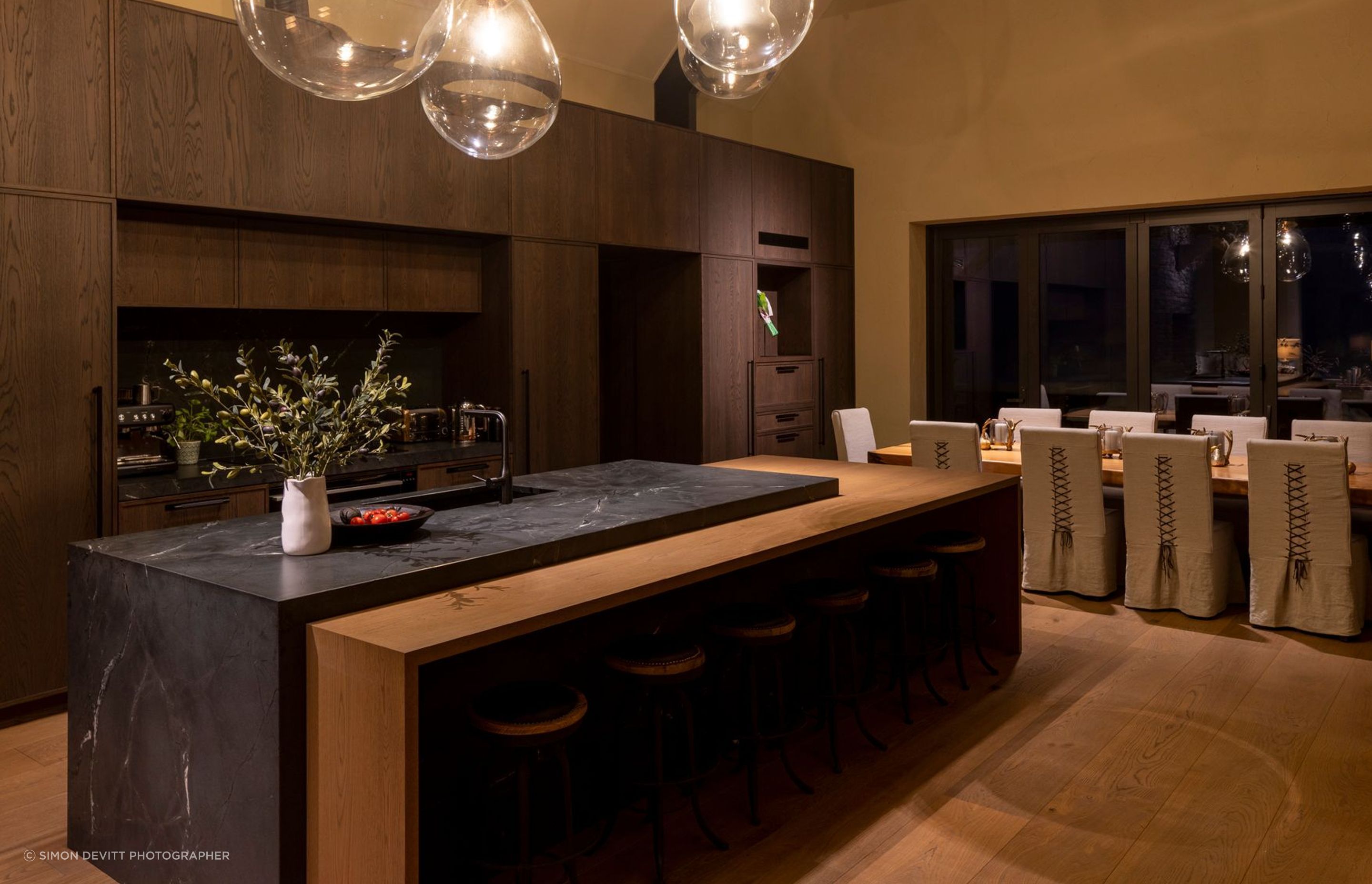 “The dining table is a swamp kauri slab from Dargaville, which was found early on and then a base was constructed for it. The dining chairs were custom made with leather detailing on the back,” says Vee.