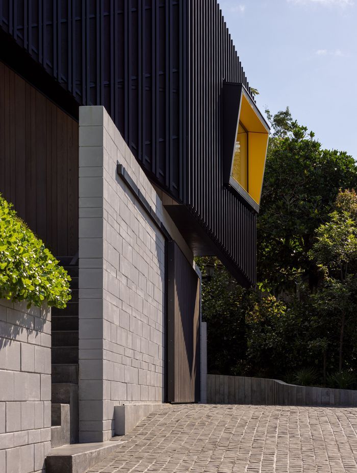 Angular windows with bright yellow soffits are orientated towards the views.