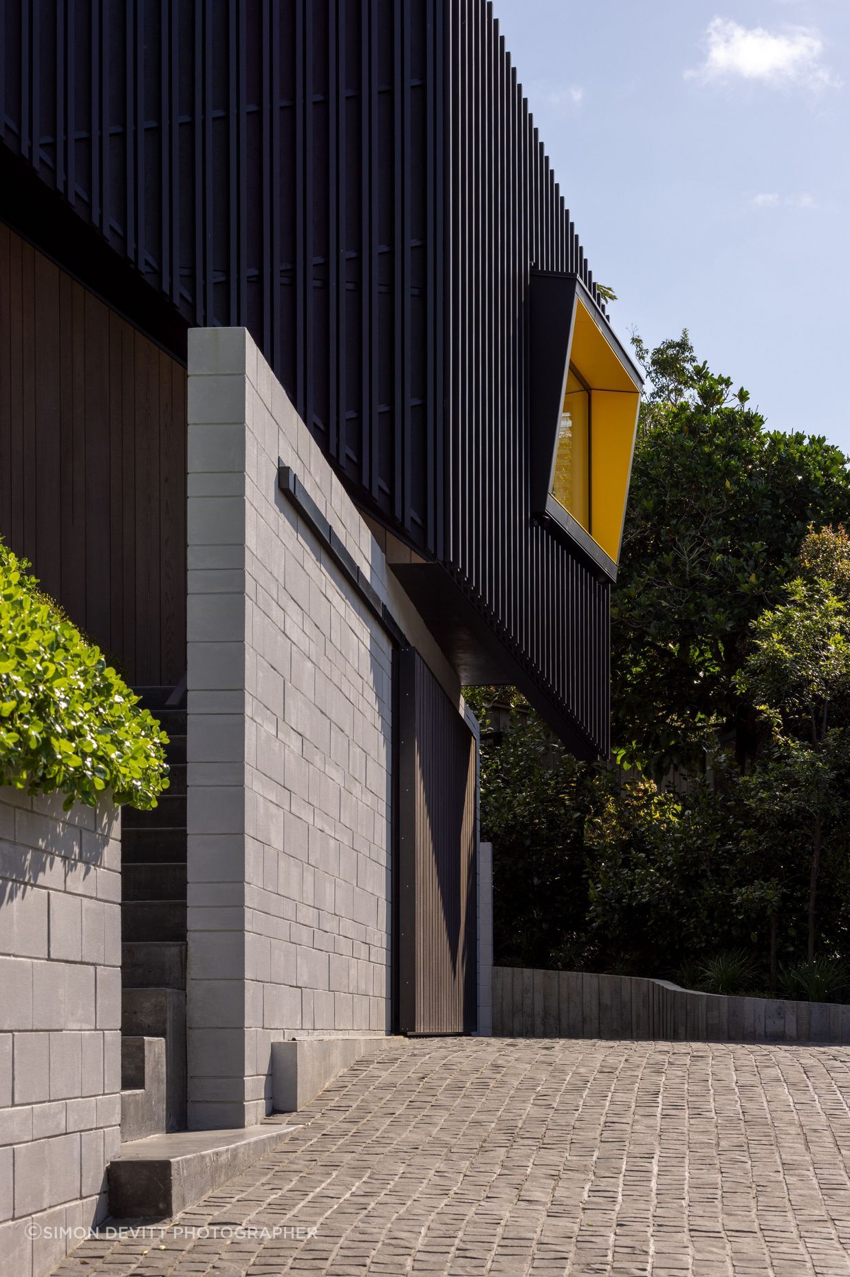 Angular windows with bright yellow soffits are orientated towards the views.