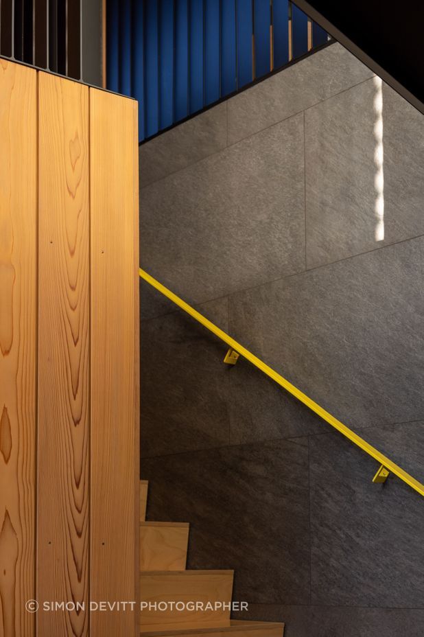 Pops of yellow are dotted around the interior spaces.