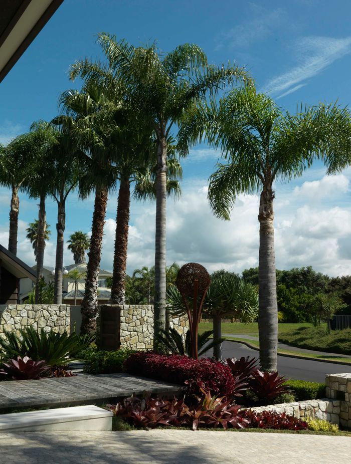 Throughout, subtropical plants complement existing, mature foliage.