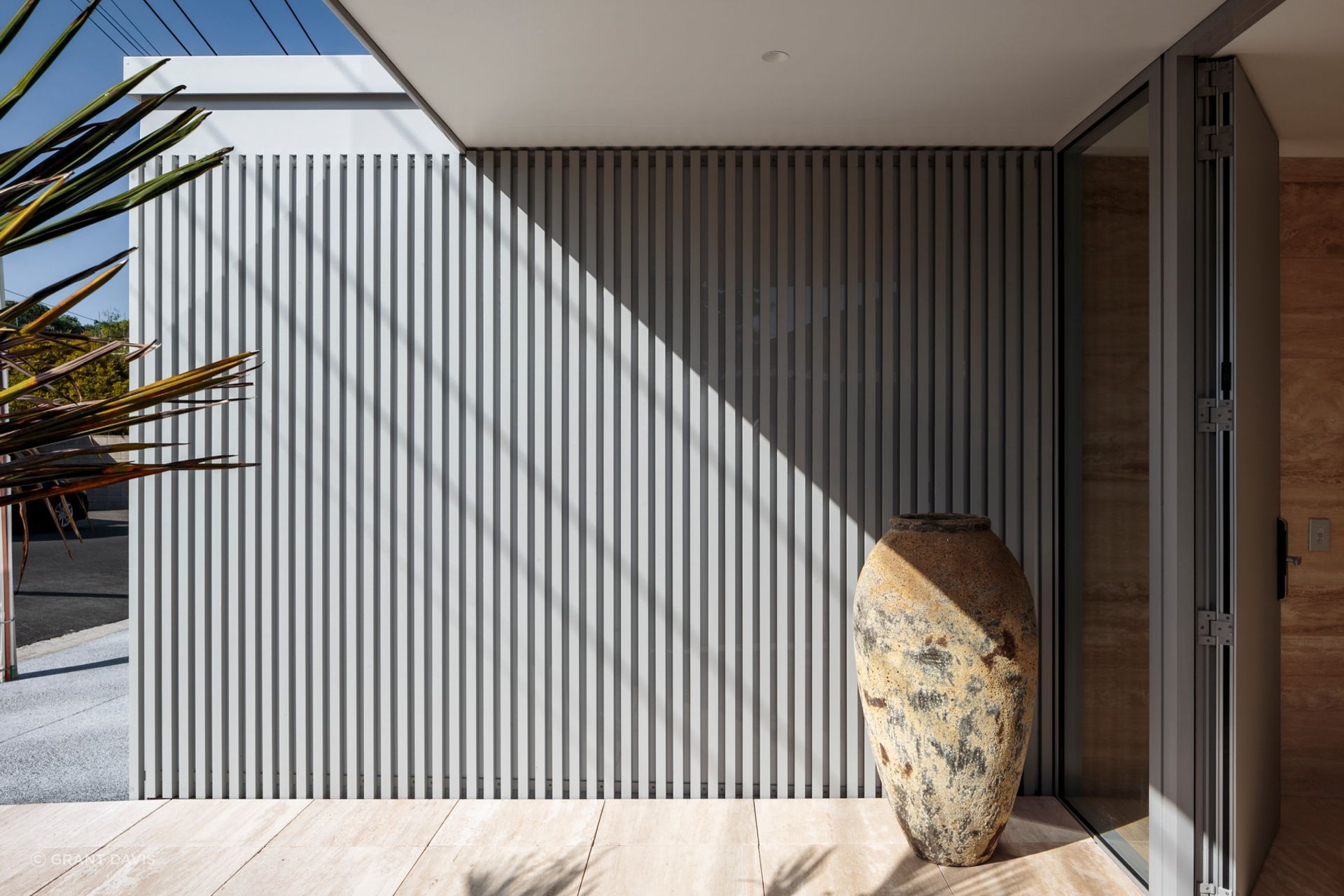 Its tiered, rectangular form is characterised by translucent cladding, aluminium battens, and just a few windows.