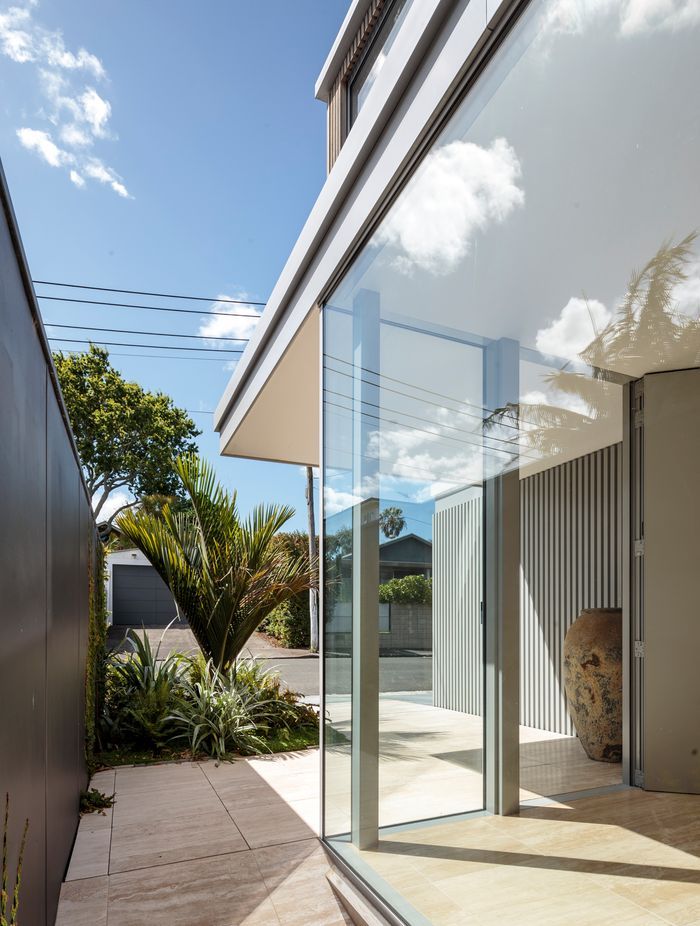 The residence is bordered by pathways leading to a back garden.