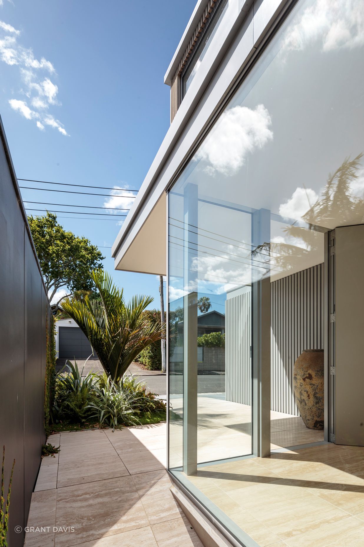 The residence is bordered by pathways leading to a back garden.