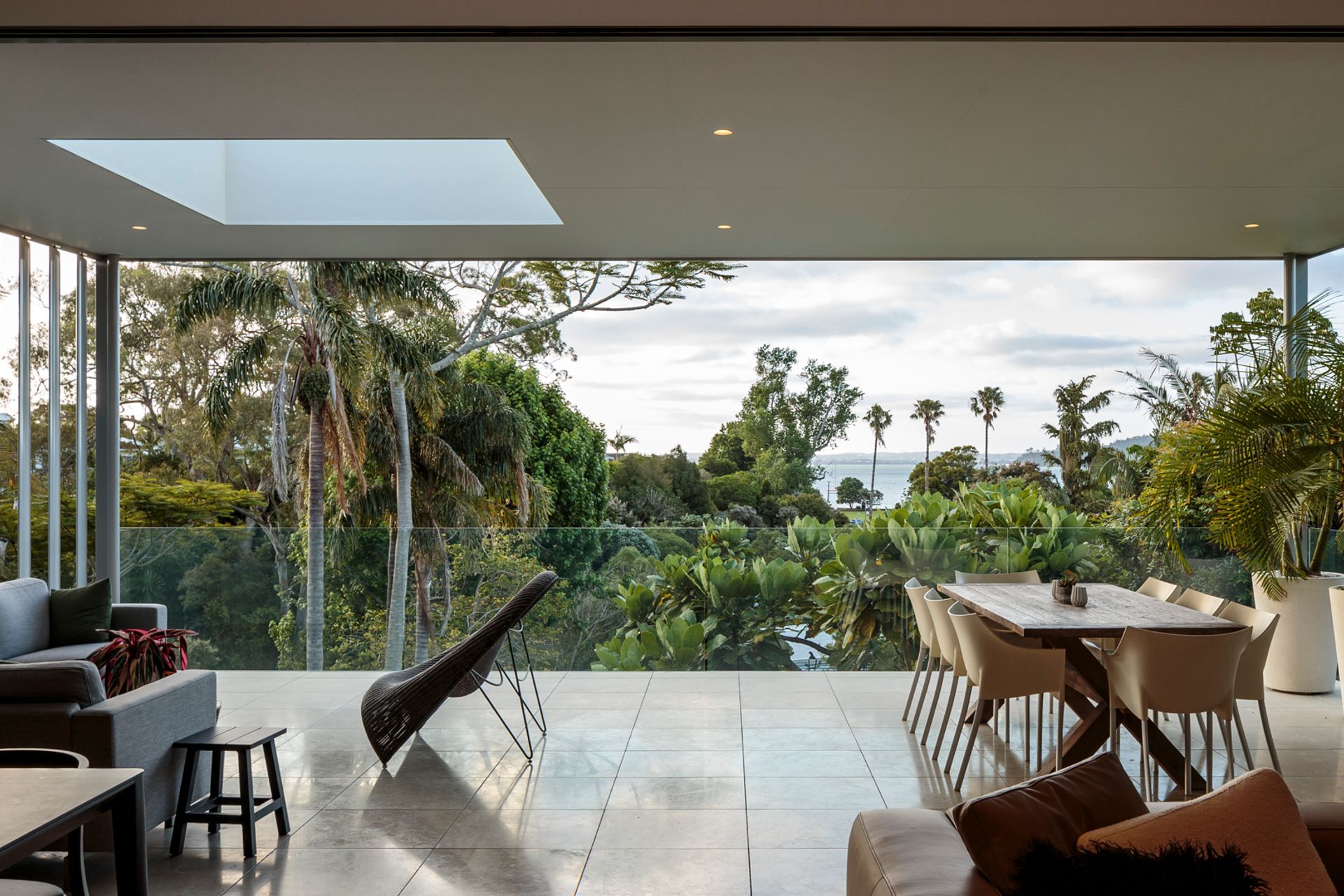 The open-plan kitchen, living and dining areas form a sanctuary, energised by height and sweeping sea views.