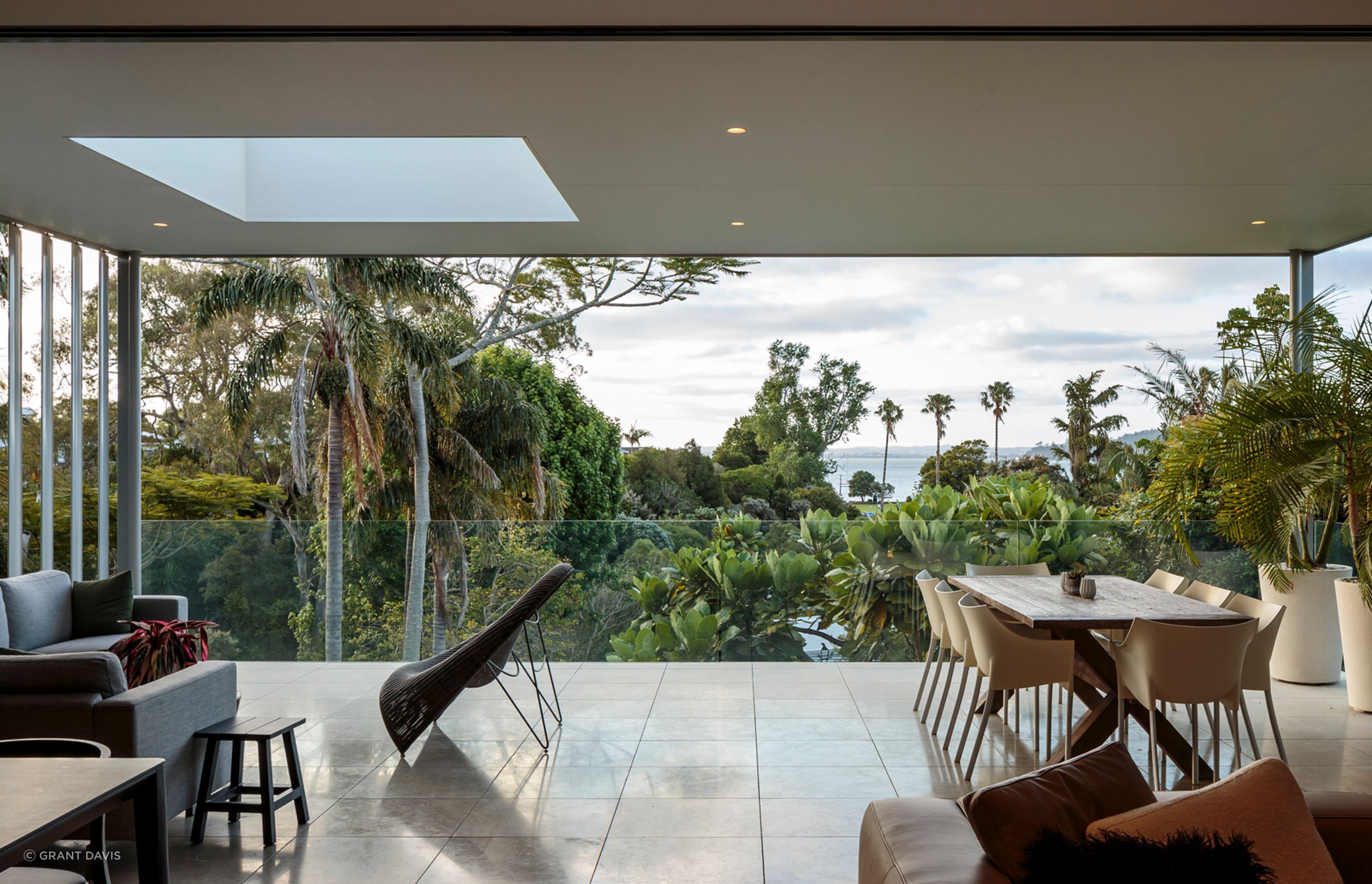 The open-plan kitchen, living and dining areas form a sanctuary, energised by height and sweeping sea views.