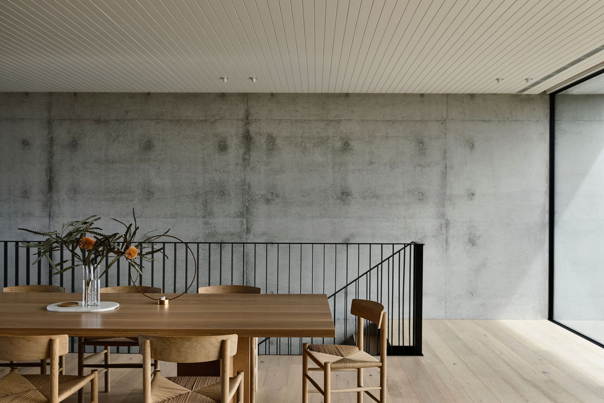 Pale timbers contrast against robust concrete structural elements.