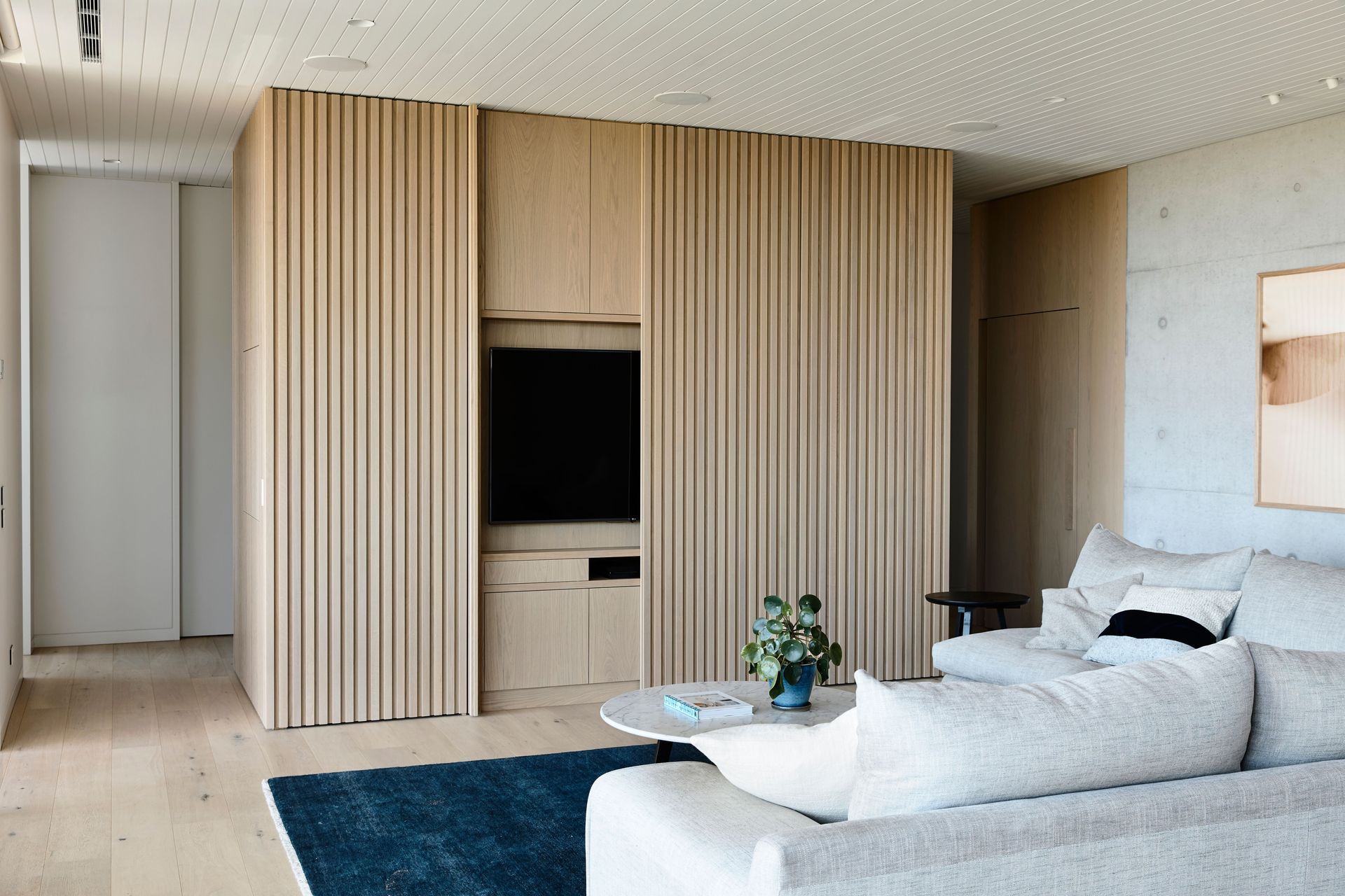 The entertainment zone is carefully concealed by panelled sliders when not in use.