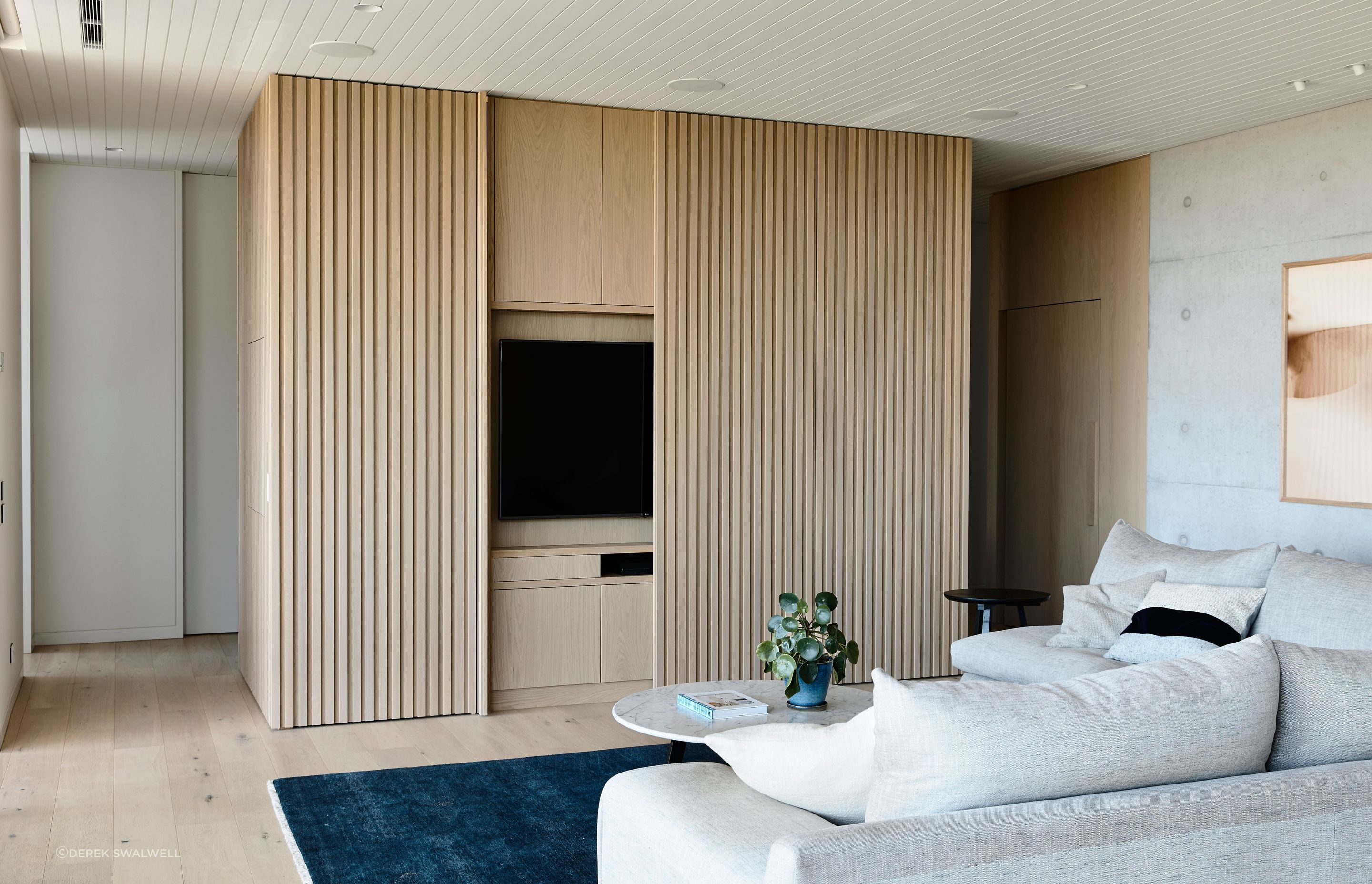 The entertainment zone is carefully concealed by panelled sliders when not in use.