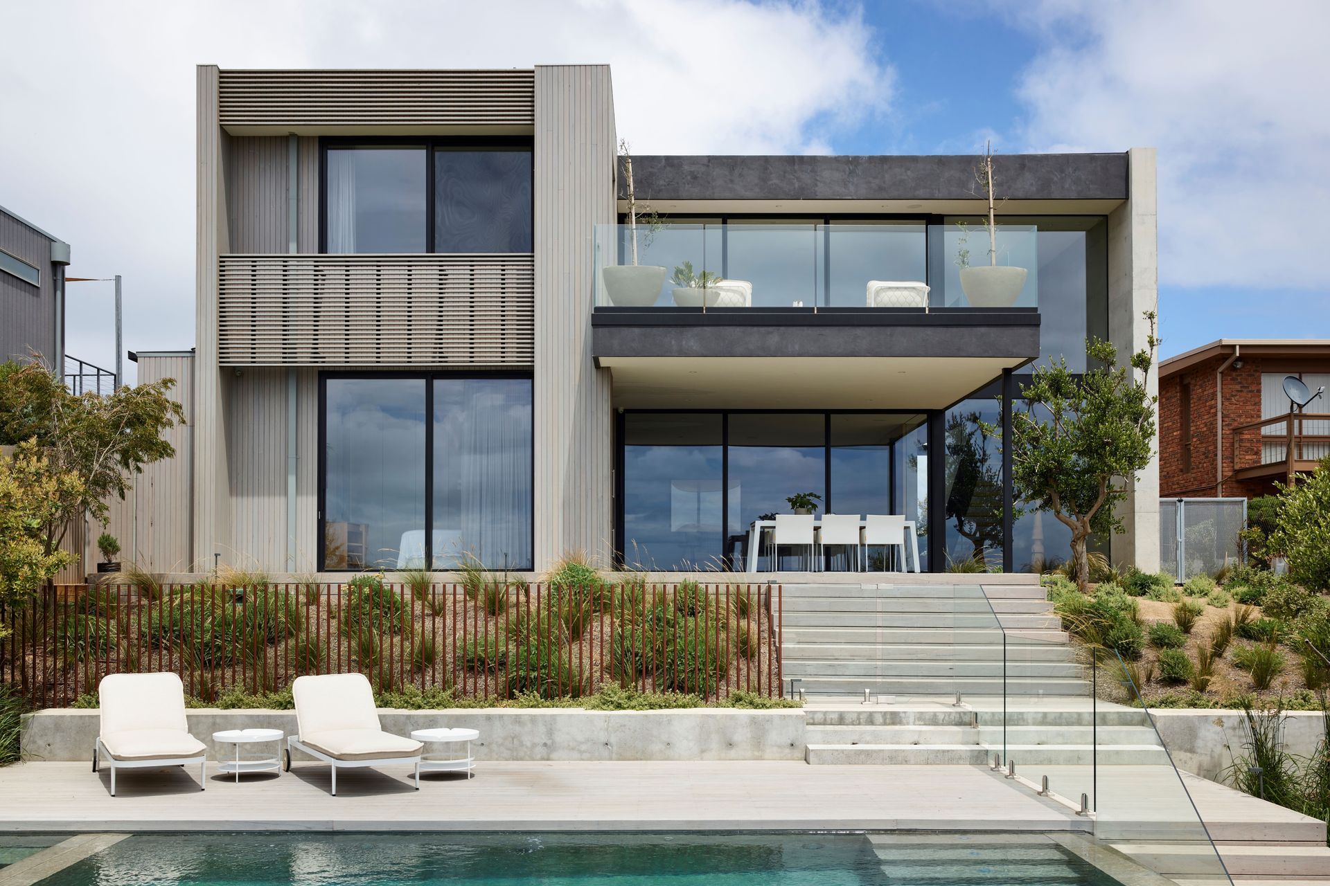 Elegant outdoor living and planters were selected to integrate with the interior palette. Planned Living Architects designed the architecture.