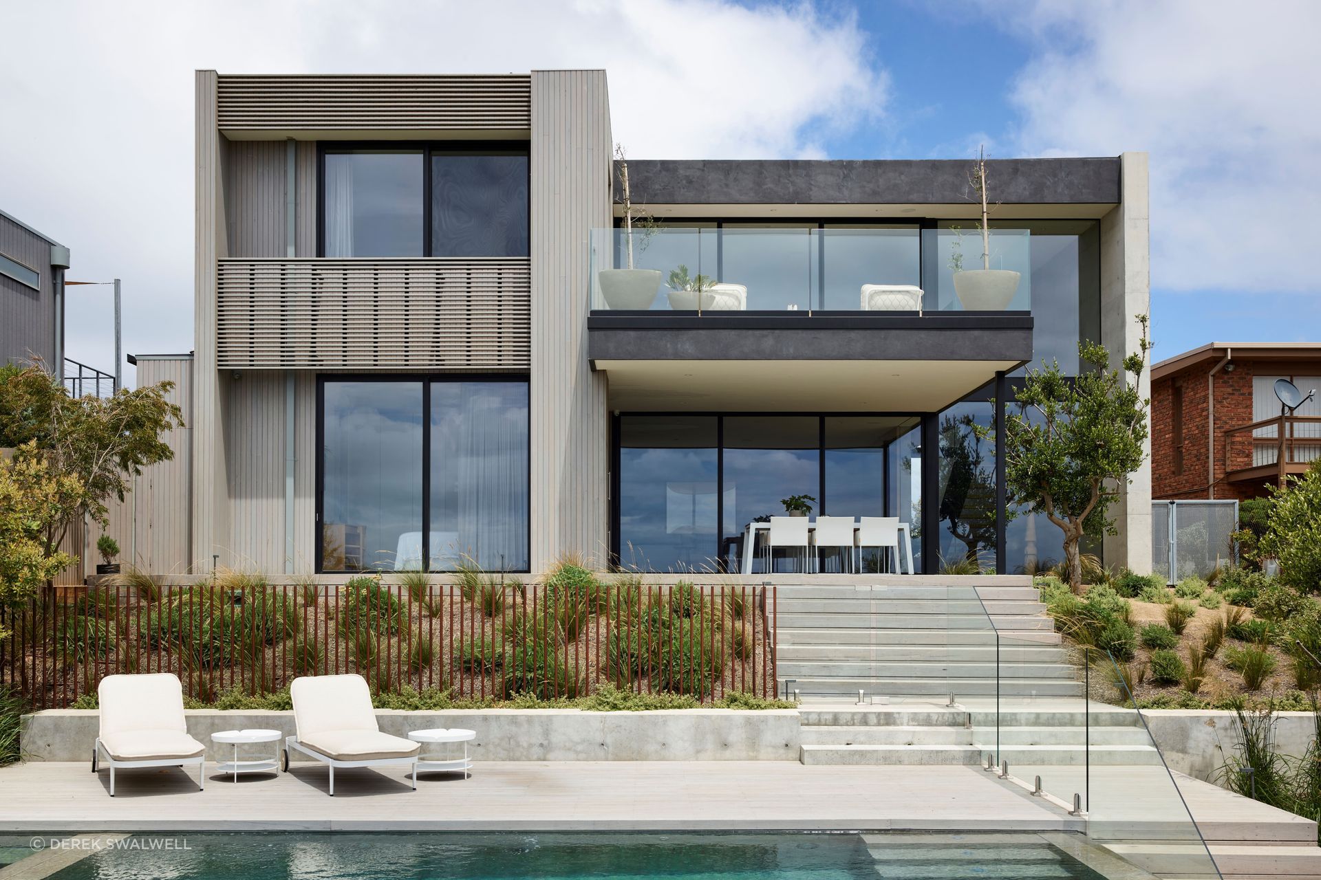 Elegant outdoor living and planters were selected to integrate with the interior palette. Planned Living Architects designed the architecture.