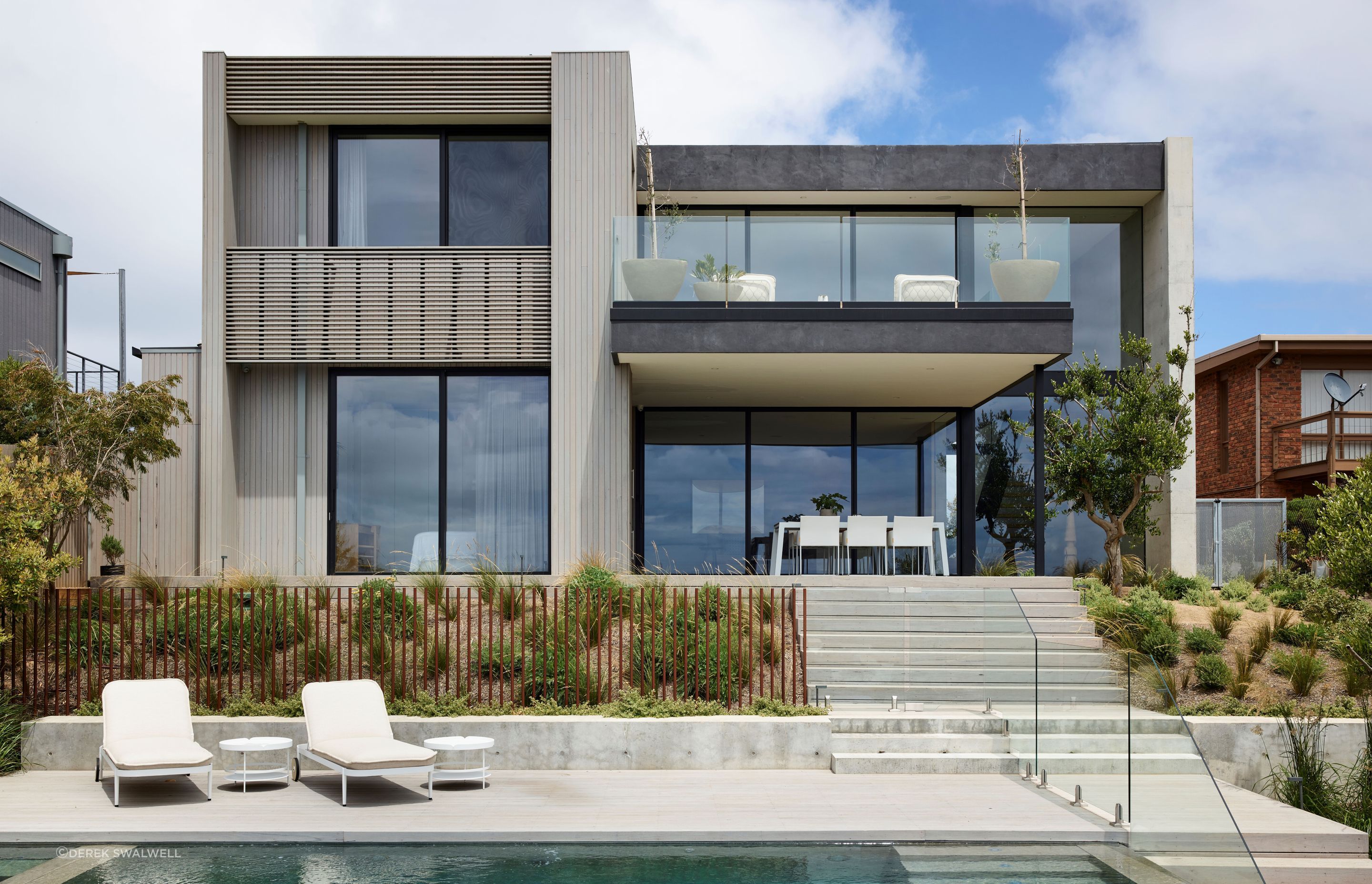 Elegant outdoor living and planters were selected to integrate with the interior palette. Planned Living Architects designed the architecture.