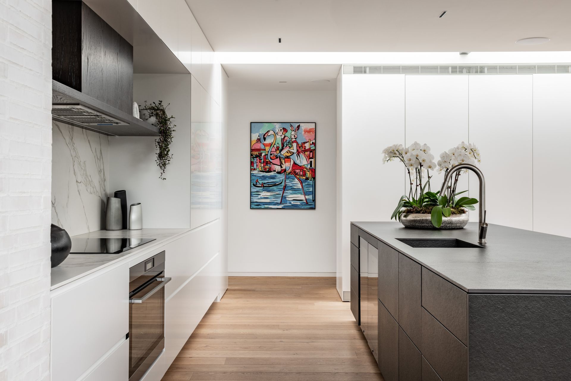 The doors to the scullery behind the joinery were especially hung so as not to expose their hinges when open, at the client’s request. The kitchen island is clad in Neolith stone. Tobin says appliances are integrated into the kitchen as much as possible. “It has two his-and-hers drink fridges built into it as well. It saves arguments.”