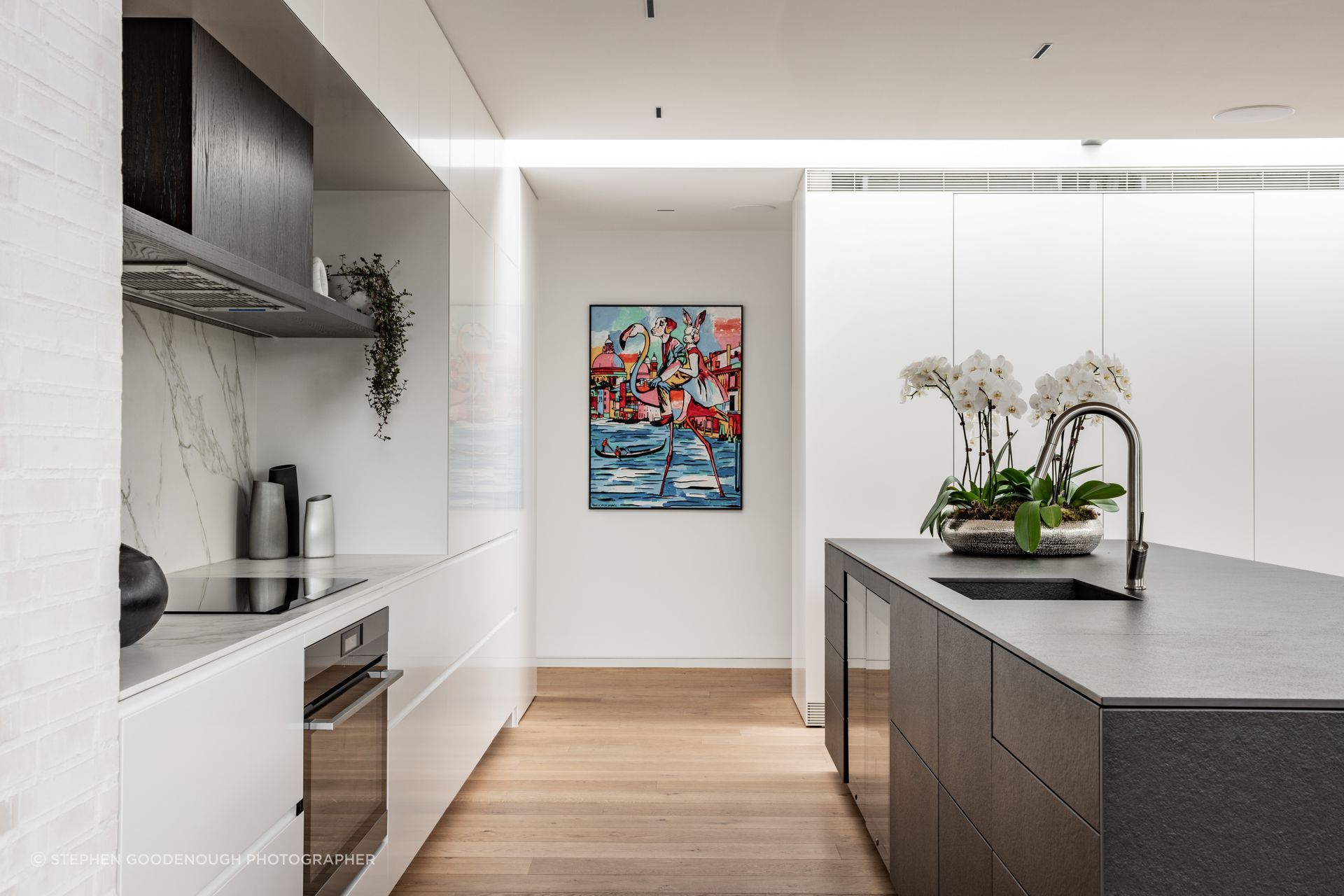 The doors to the scullery behind the joinery were especially hung so as not to expose their hinges when open, at the client’s request. The kitchen island is clad in Neolith stone. Tobin says appliances are integrated into the kitchen as much as possible. “It has two his-and-hers drink fridges built into it as well. It saves arguments.”