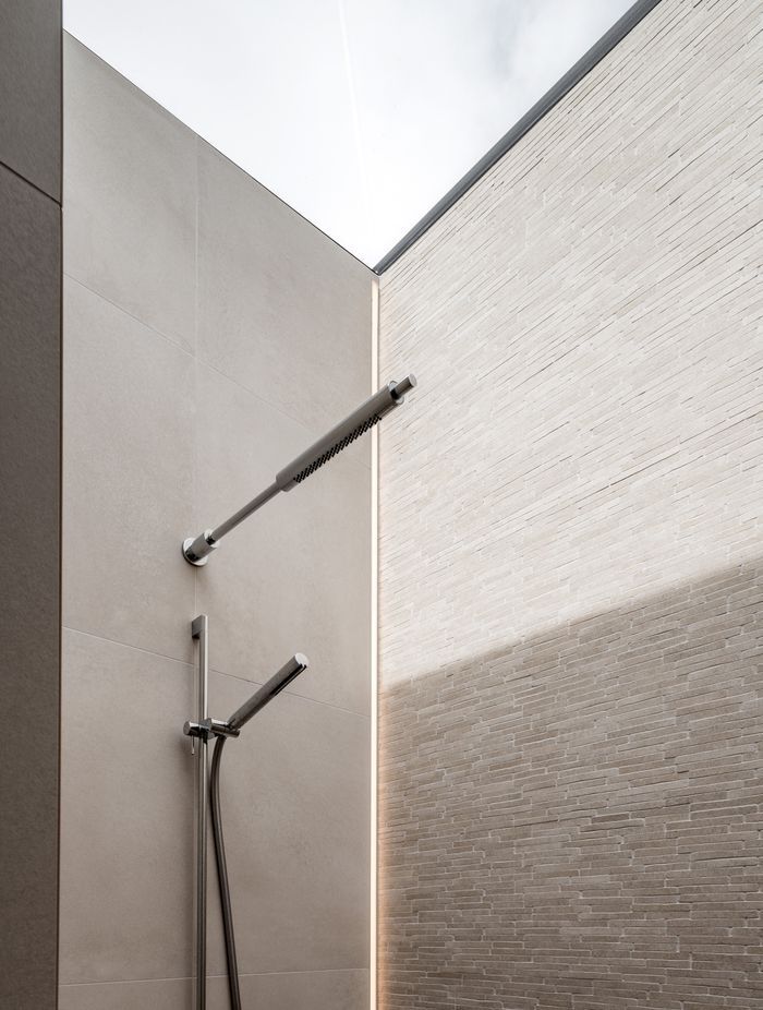 The shower had a skylight over the entire thing so there was nowhere to put a light. We actually recessed an LED strip vertically into the tile.”