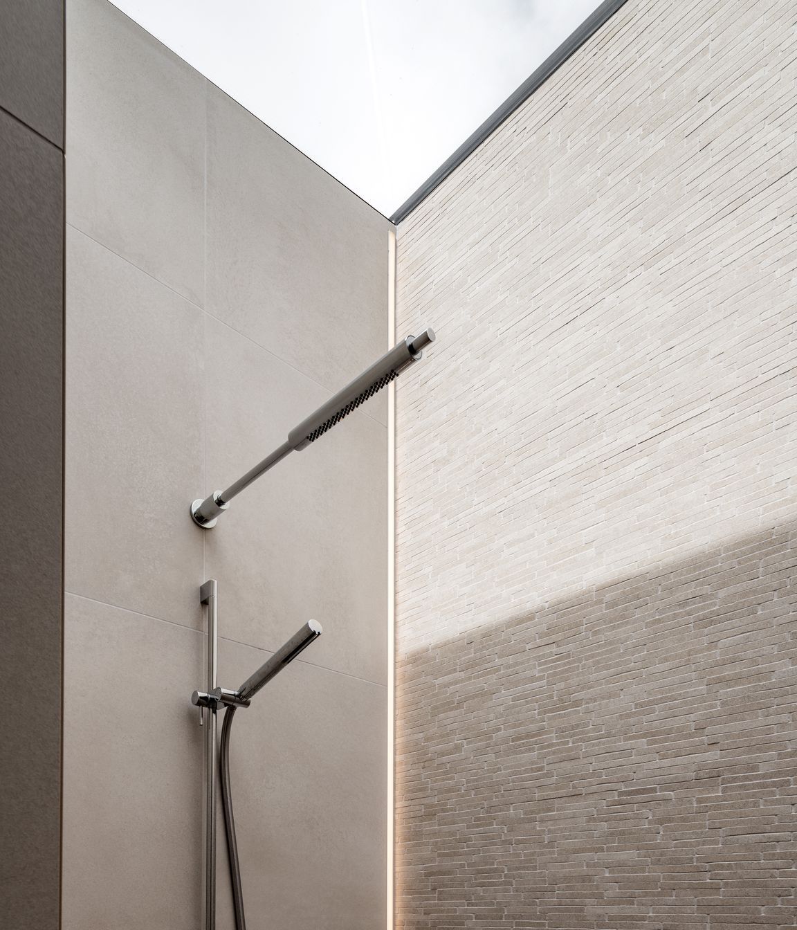 The shower had a skylight over the entire thing so there was nowhere to put a light. We actually recessed an LED strip vertically into the tile.”