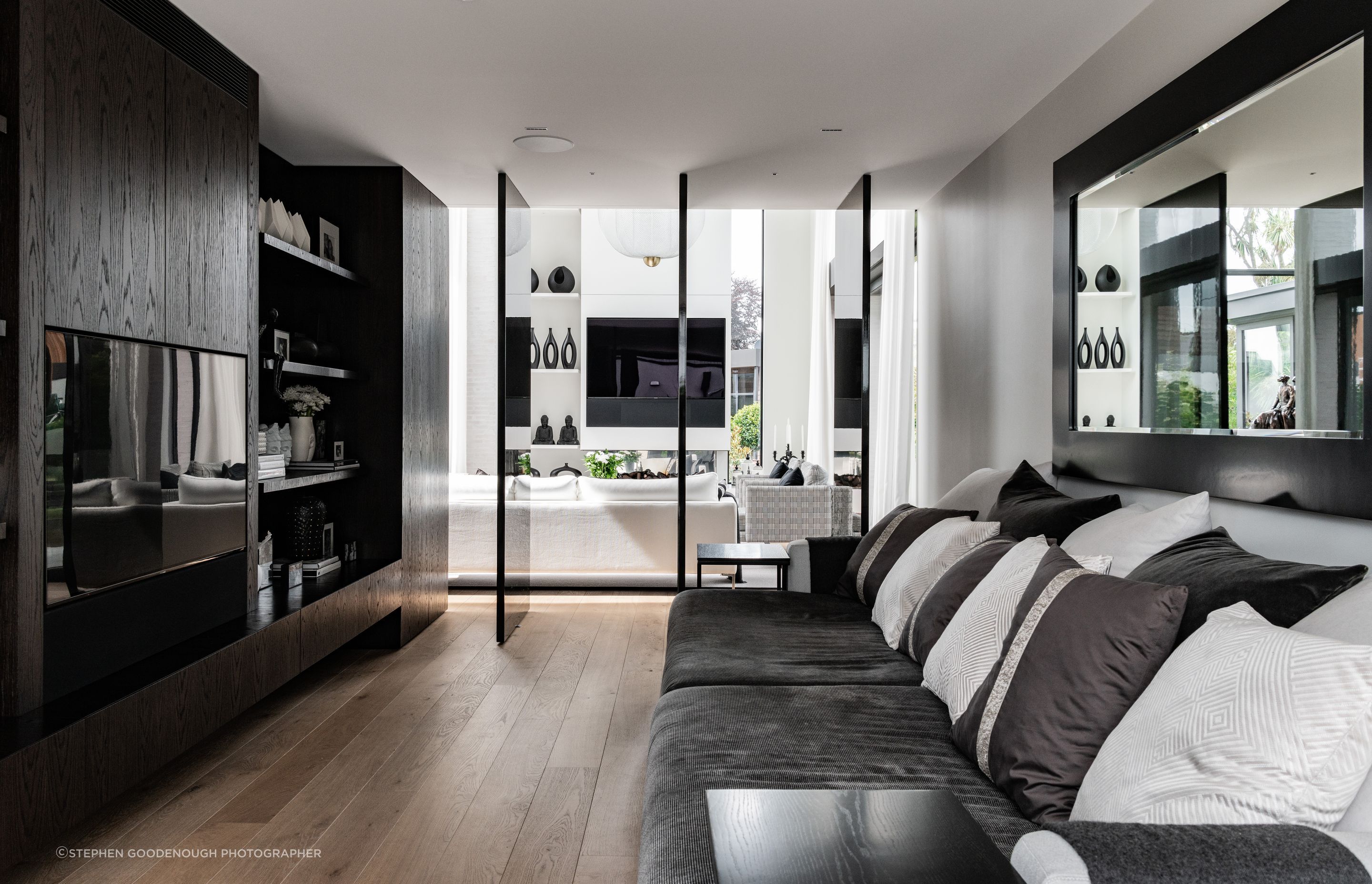 The sitting room off the master bedroom. “Those pivot doors engage with the main living space but when they want to use it they just close it down. It almost becomes their own living room, particularly if they have guests over. It’s a darker, more intimate space,” says Tobin.