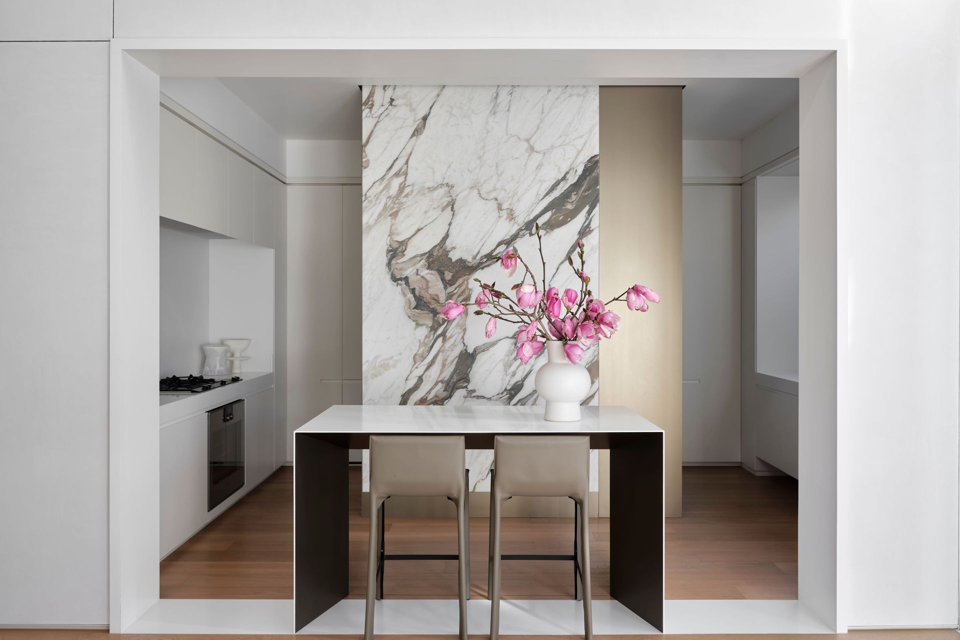 A jaw-dropping stone slab creates drama in the kitchen; the kitchen bar takes place of a traditional island.