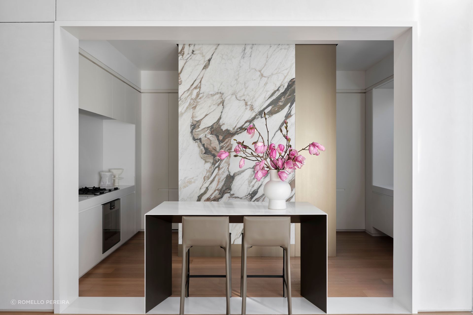 A jaw-dropping stone slab creates drama in the kitchen; the kitchen bar takes place of a traditional island.