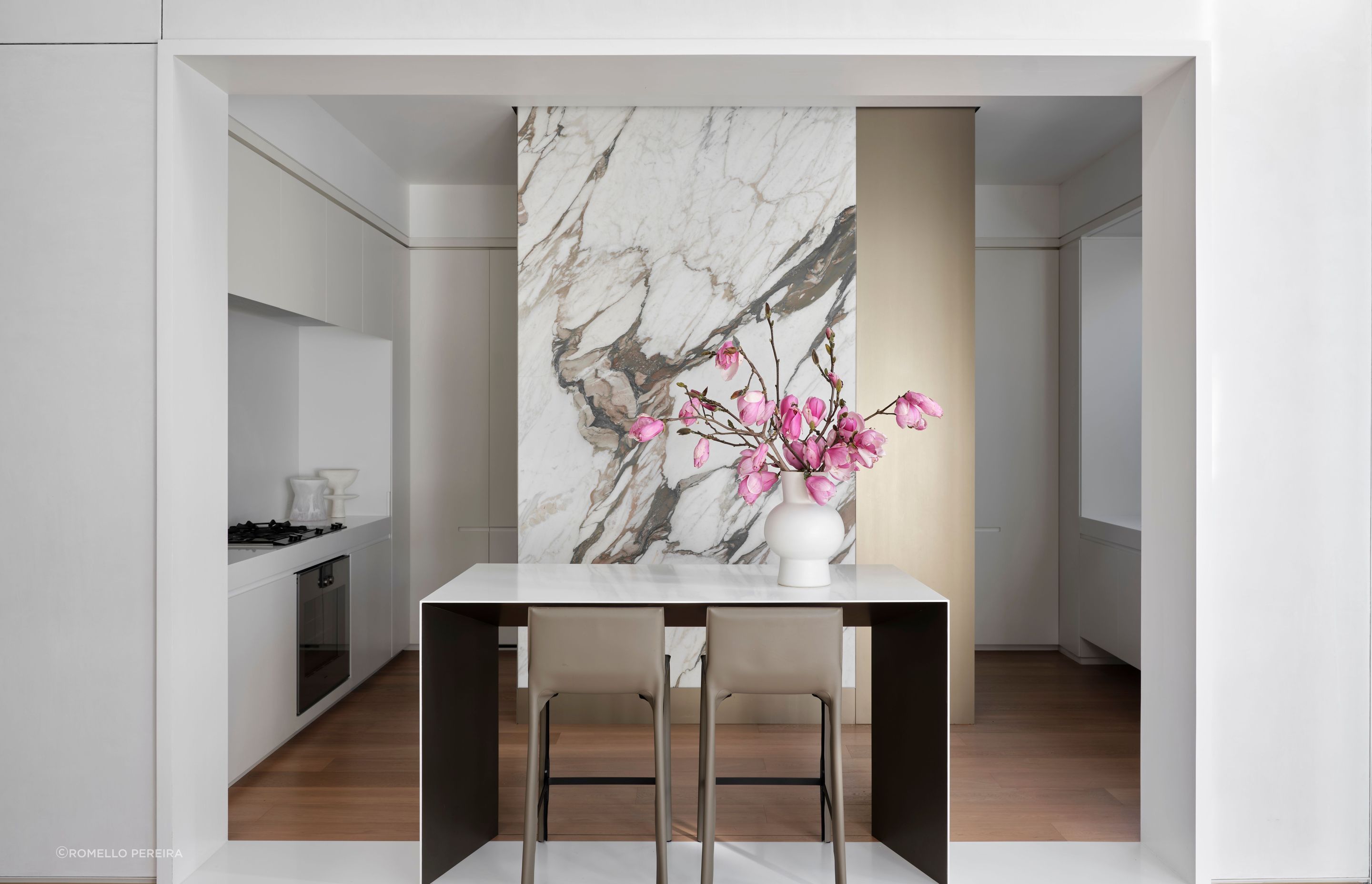 A jaw-dropping stone slab creates drama in the kitchen; the kitchen bar takes place of a traditional island.