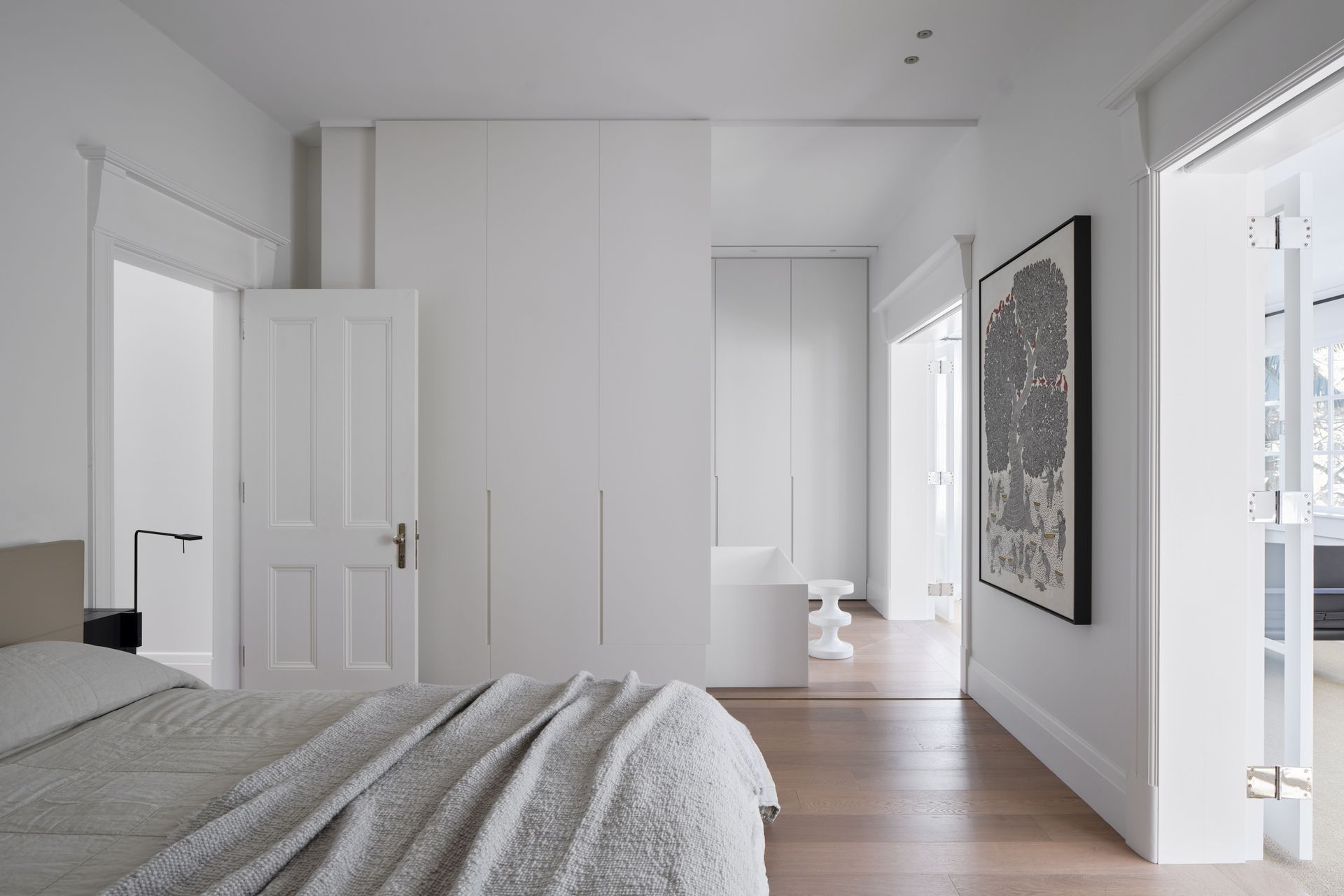 The master suite transitions to a pale and serene ensuite with freestanding bath.