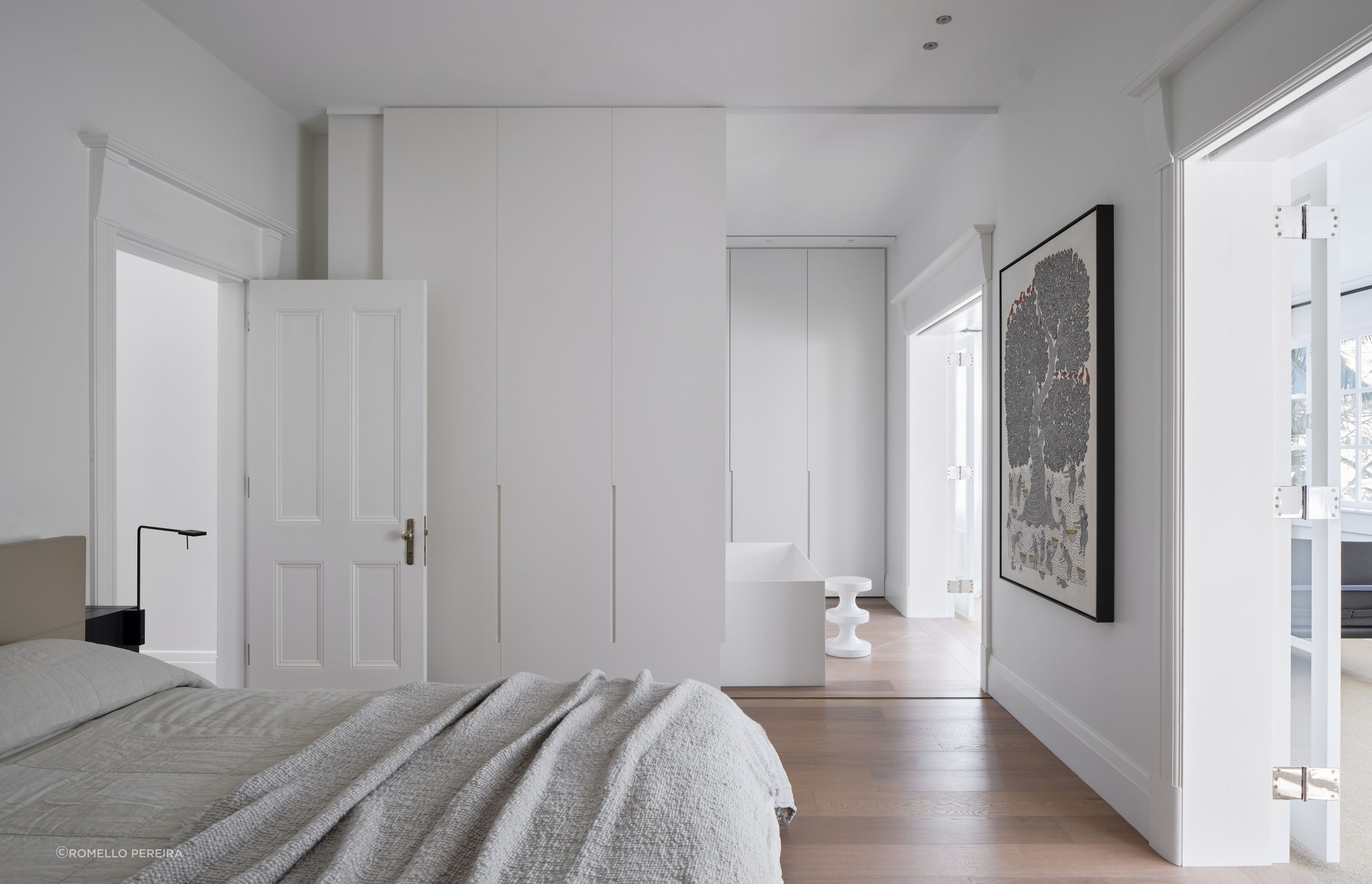 The master suite transitions to a pale and serene ensuite with freestanding bath.
