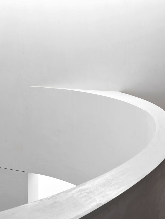 The curve of the mezzanine banister creates a strong gestural move in the new space.