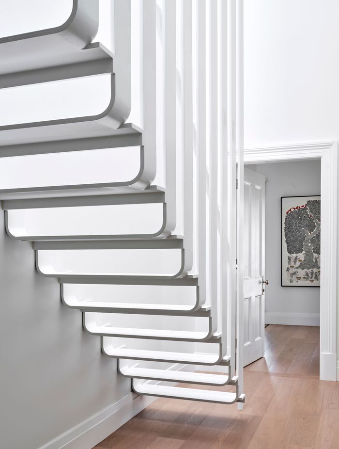 The upstairs mezzanine is accessed by sculptural stairs, celebrating the contrast of traditional and contemporary.