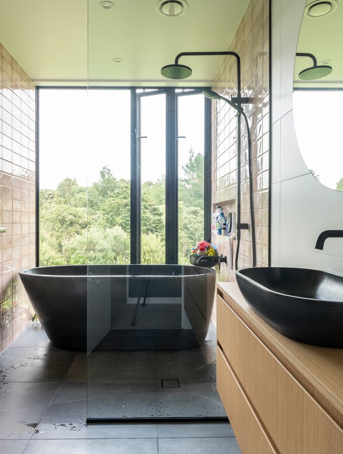 In the master suite, a standalone tub is the perfect private spot for respite and a view of the bush.