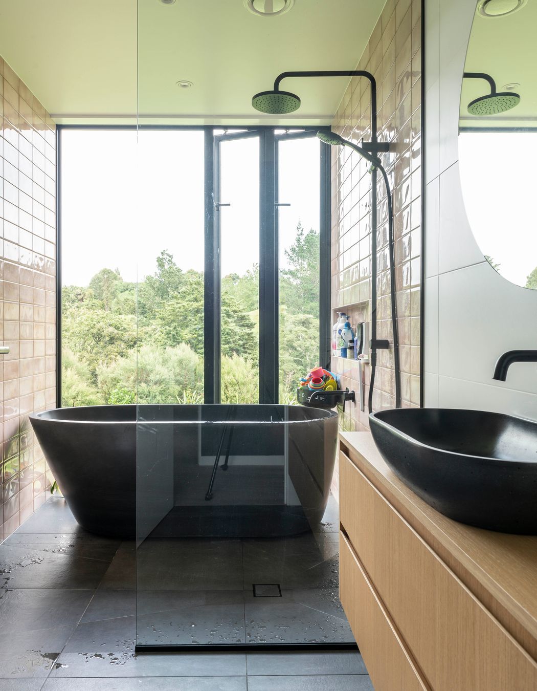 In the master suite, a standalone tub is the perfect private spot for respite and a view of the bush.