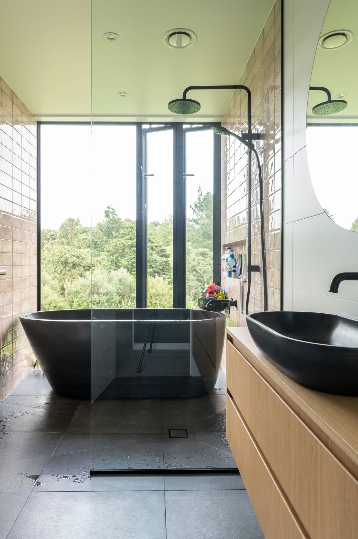 In the master suite, a standalone tub is the perfect private spot for respite and a view of the bush.