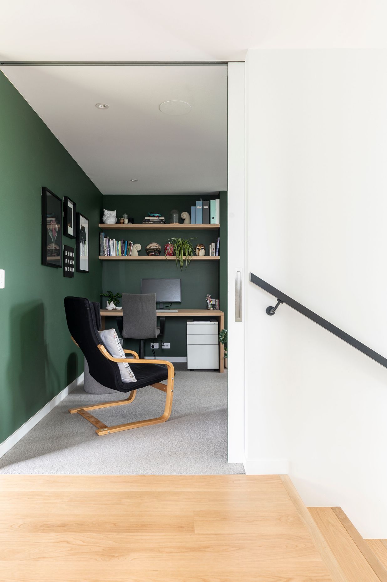 An office space features calm, forest-green walls.