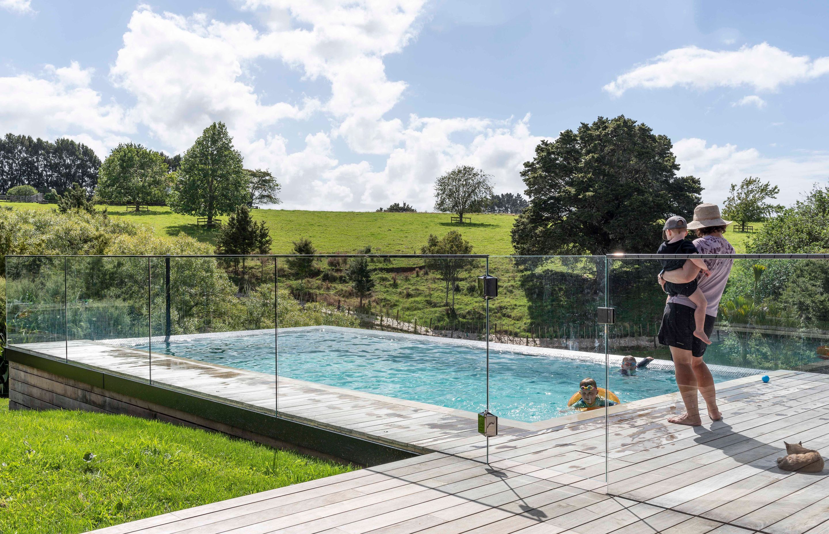 The family enjoys the stunning rural views across the land from the pool.
