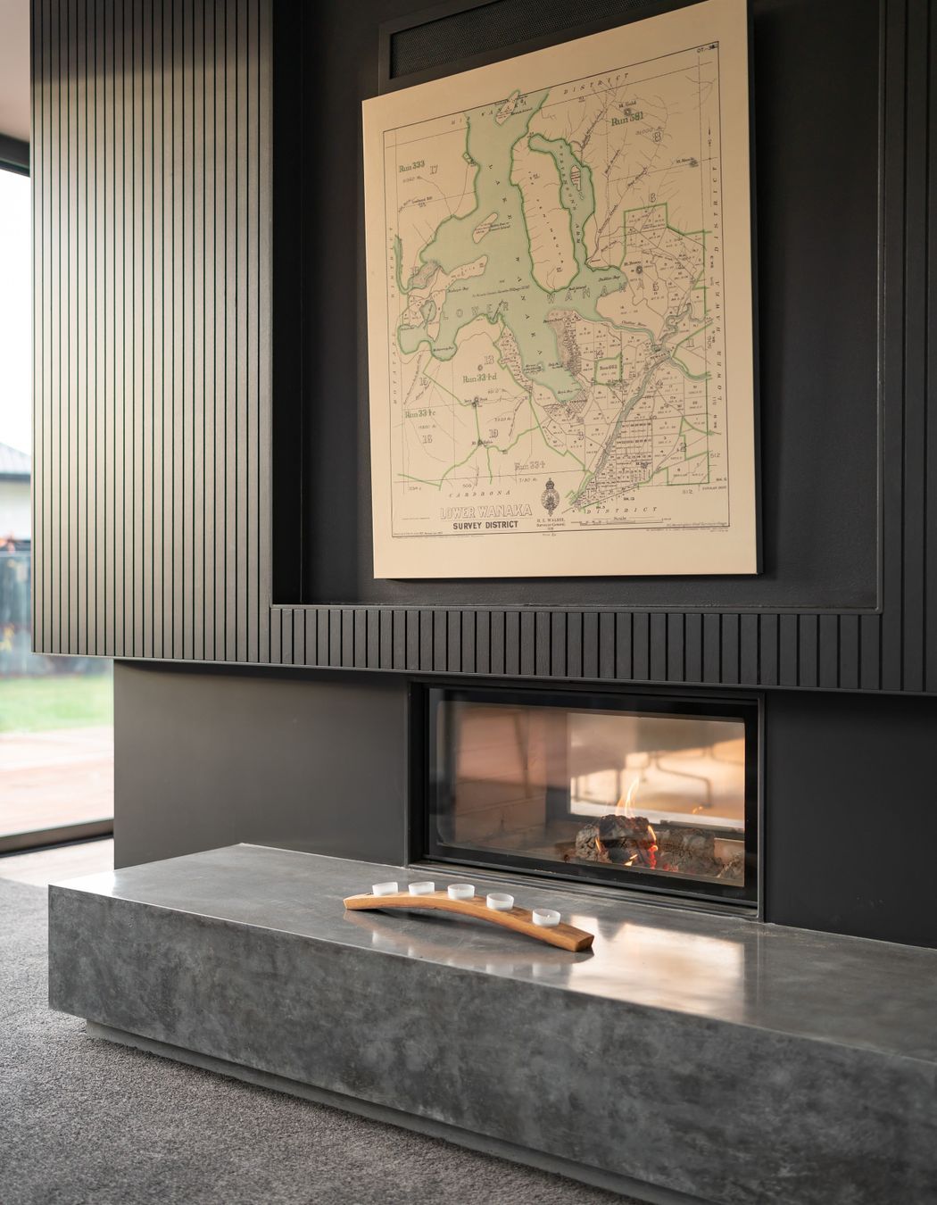 The Escea Spartherm double-sided fireplace divides two living areas without completely separating them.