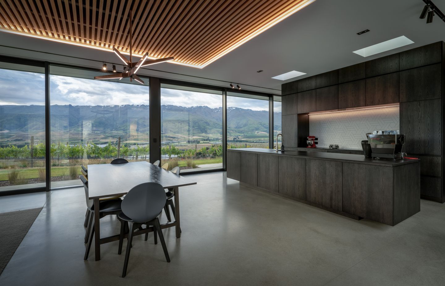The kitchen and dining area, positioned to capture the outlook of the vineyard and Pisa mountain range. | Photographer: Simon Larkin