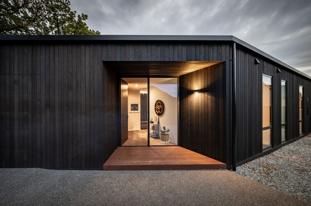 “I tend to play a bit with scale. Those entry doors are 2.7 metres tall so although it looks small and compact, when you get there it's quite a big dwelling.” The cedar cladding is by Rosenfeld Kidson.