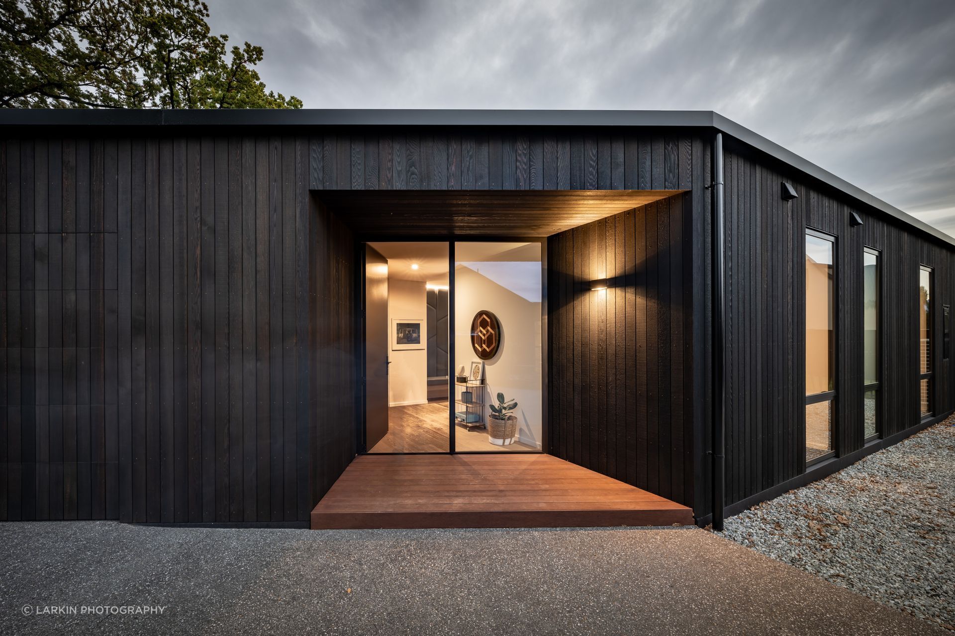 “I tend to play a bit with scale. Those entry doors are 2.7 metres tall so although it looks small and compact, when you get there it's quite a big dwelling.” The cedar cladding is by Rosenfeld Kidson.