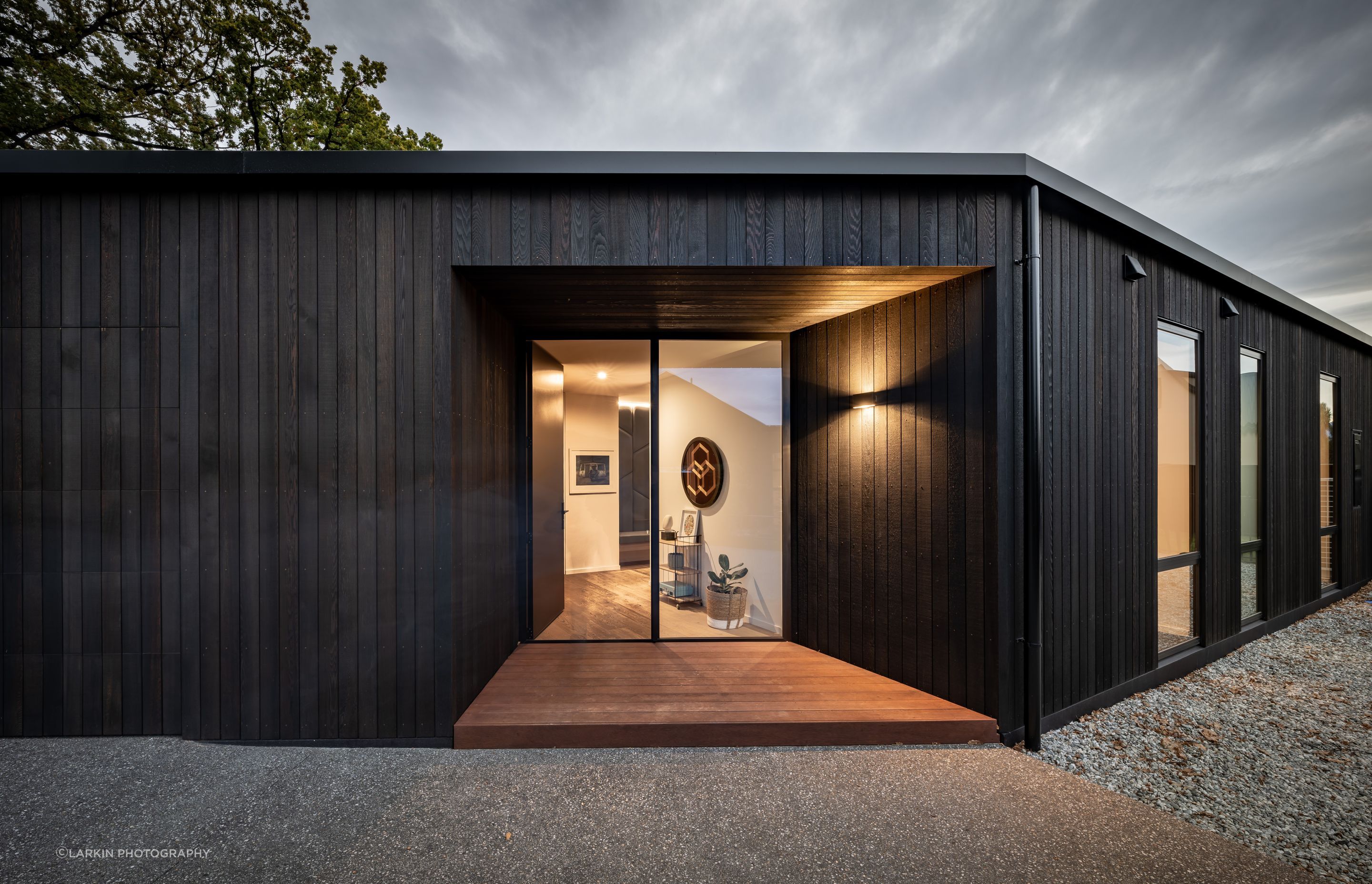 “I tend to play a bit with scale. Those entry doors are 2.7 metres tall so although it looks small and compact, when you get there it's quite a big dwelling.” The cedar cladding is by Rosenfeld Kidson.
