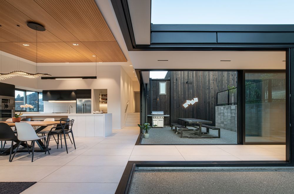 Looking across the linkway into the internal courtyard. The clients had a lot of input into the kitchen design. “One of the couple is a chef so the kitchen was important.”