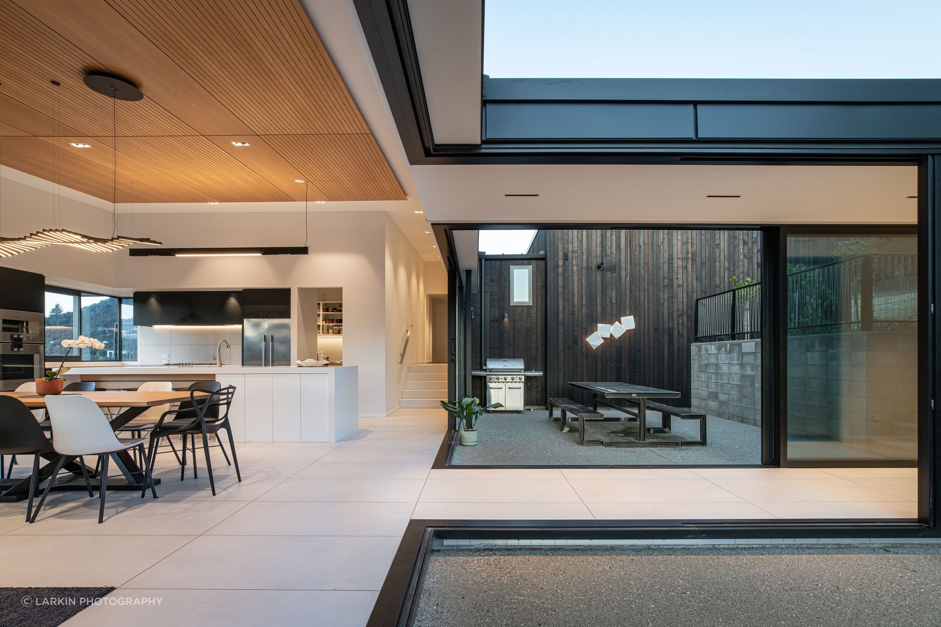 Looking across the linkway into the internal courtyard. The clients had a lot of input into the kitchen design. “One of the couple is a chef so the kitchen was important.”