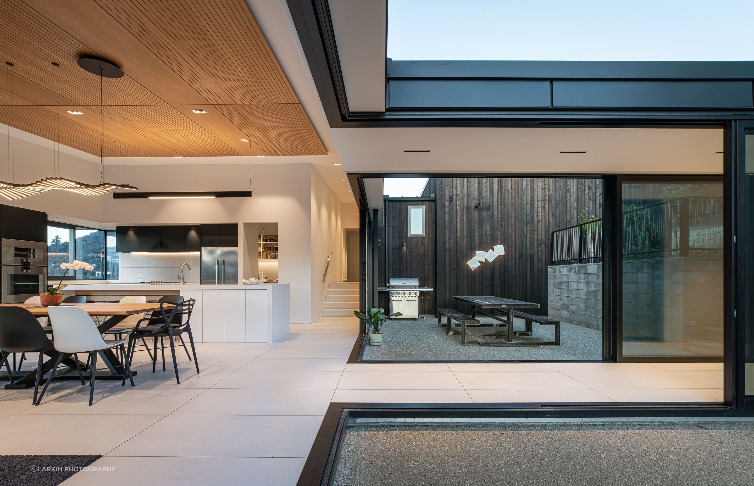 Looking across the linkway into the internal courtyard. The clients had a lot of input into the kitchen design. “One of the couple is a chef so the kitchen was important.”