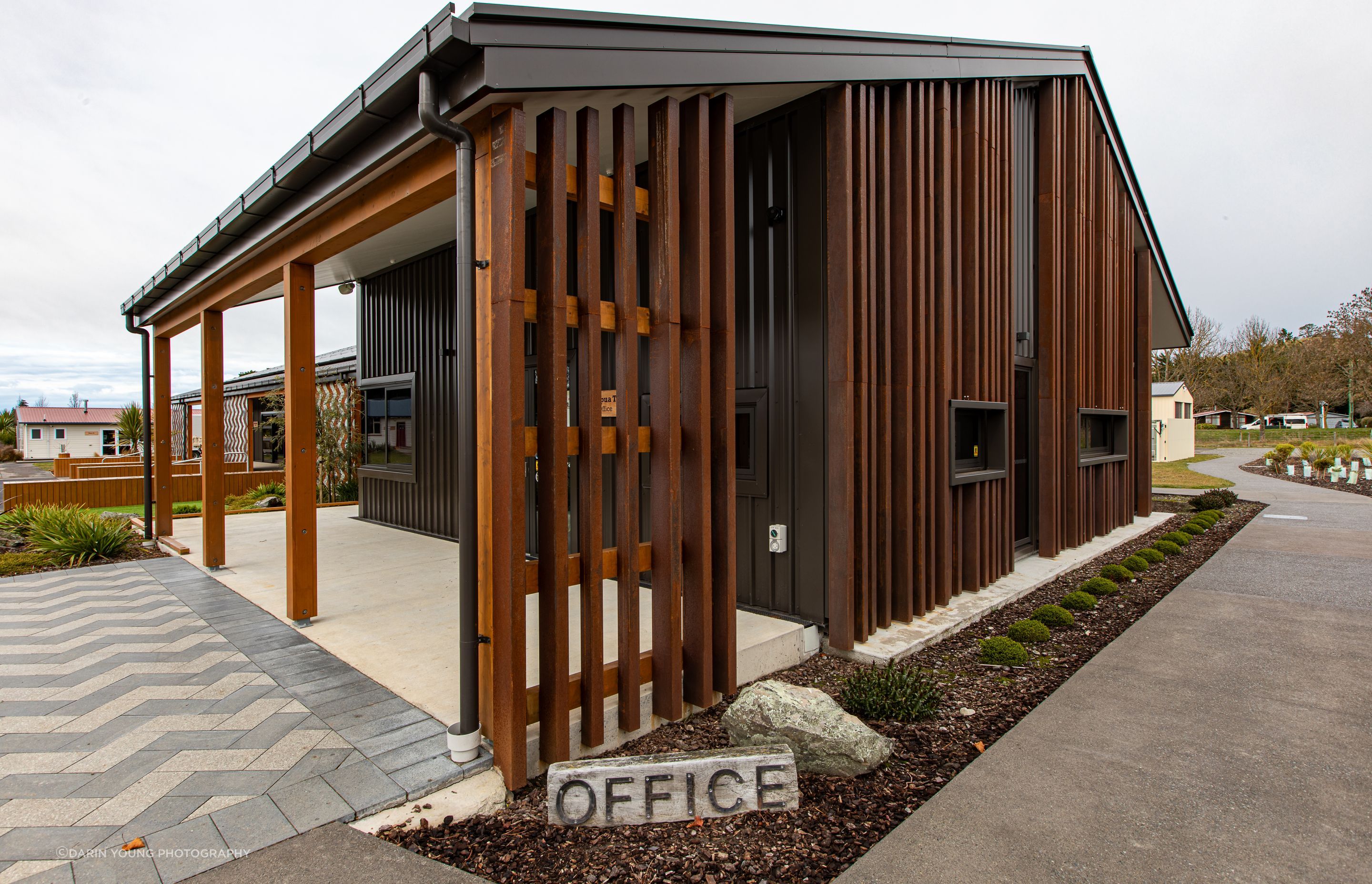 The basket weave of the rain screens is also reflected on the landscaping by Kamo Marsh.