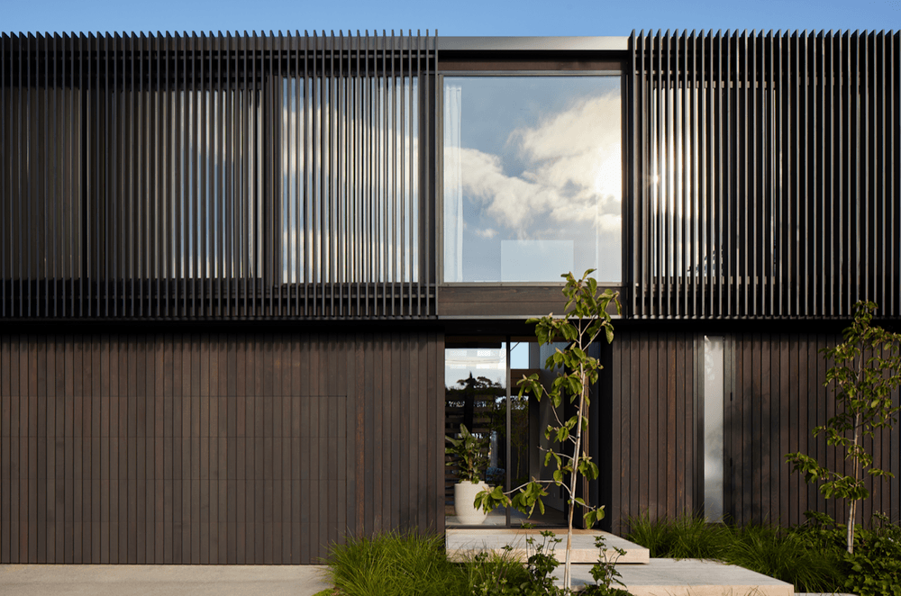 Vertical cedar cladding and aluminium fins create a dramatic visual.