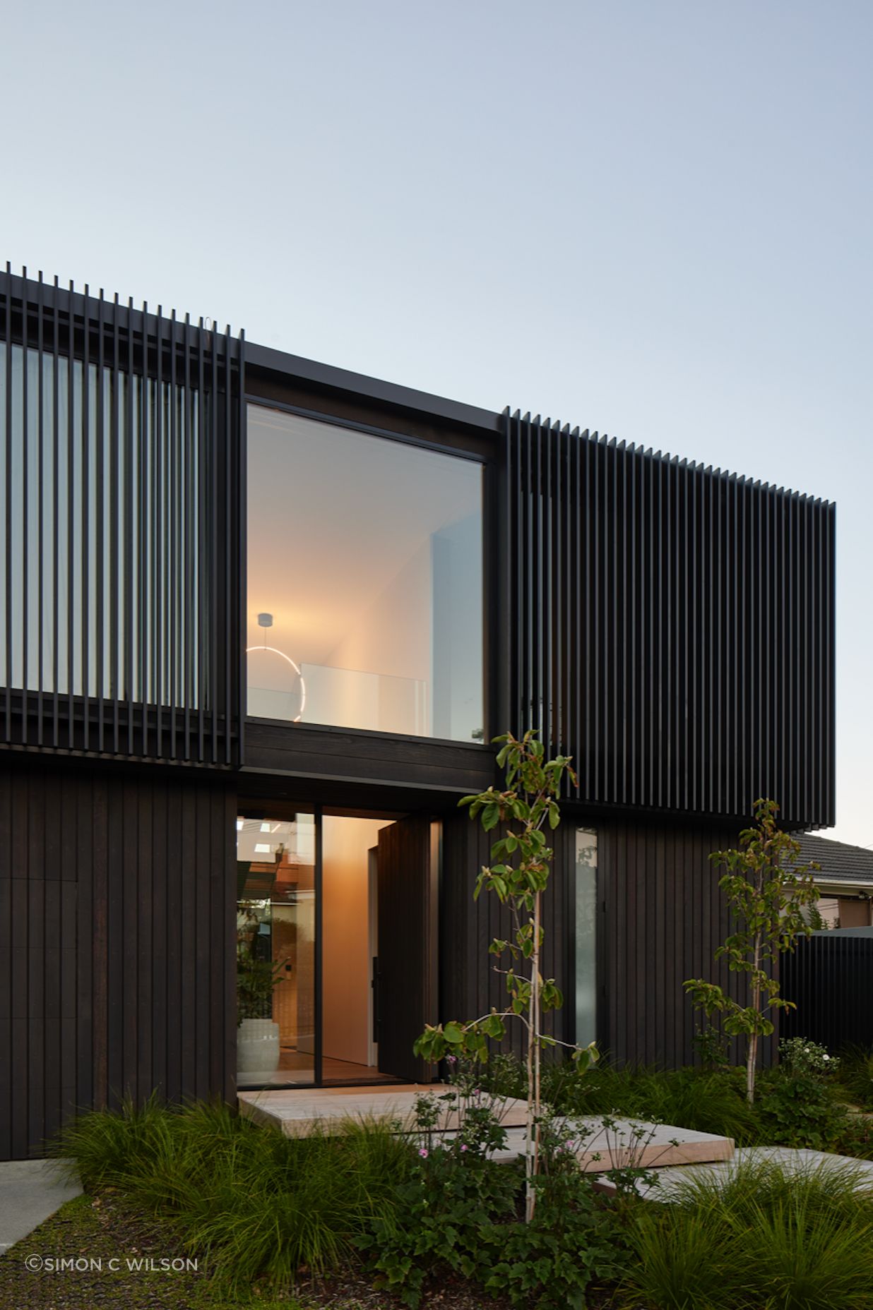 Beautiful landscaping leads to the front entrance.