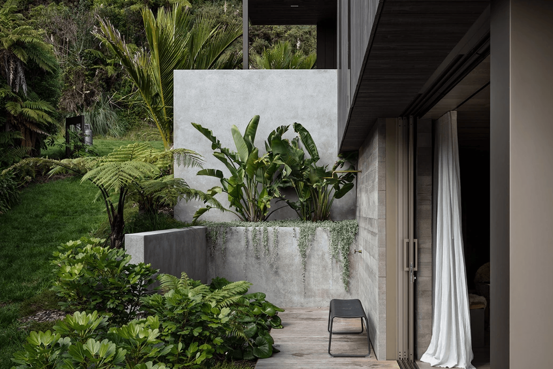 The outdoor shower. “There’s a double wall of concrete and the doors slide into a pocket between them. It looks easy, but actually building it is a real challenge,” says Evelyn. She mapped out the gardens, and Flora and Form designed and planted them.